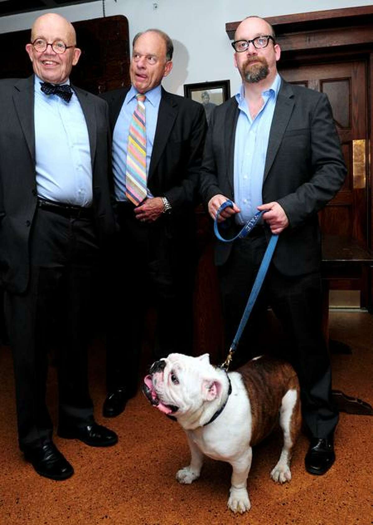 Left to right, Douglas Rae, Chairman of the Board of Governors of Mory's, Robert Blanchard, Mory's Council member, and actor Paul Giamatti are photographed Tuesday at Mory's in New Haven with the Yale mascot, Handsome Dan. Arnold Gold/Register