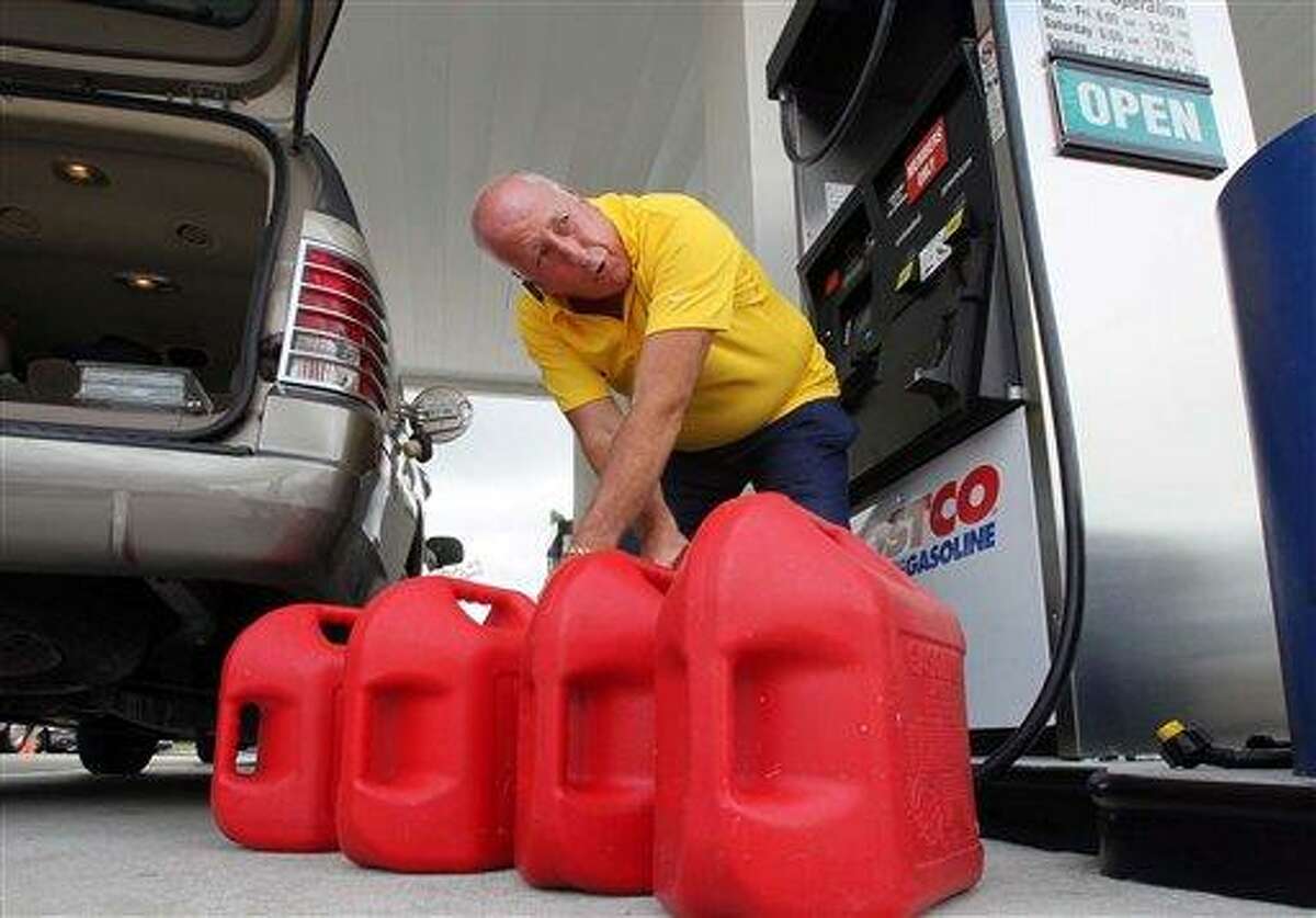 Jay Coleman fills up spare gasoline containers at Costco in preparation for Hurricane Irene, Monday, Aug. 22, 2011, in Royal Palm Beach, Fla. The U.S. National Hurricane Center projected that Irene could grow into a Category 3 hurricane with winds of 115 mph (184 kph) over the Bahamas on Thursday. And it may carry that force northwest along Florida's Atlantic coast and toward a possible strike on South Carolina, though the forecasters warned that by the weekend, the storm's path could vary significantly from the current projection. (AP Photo/The Palm Beach Post, Allen Eyestone) MAGS OUT; TV OUT; NO SALES