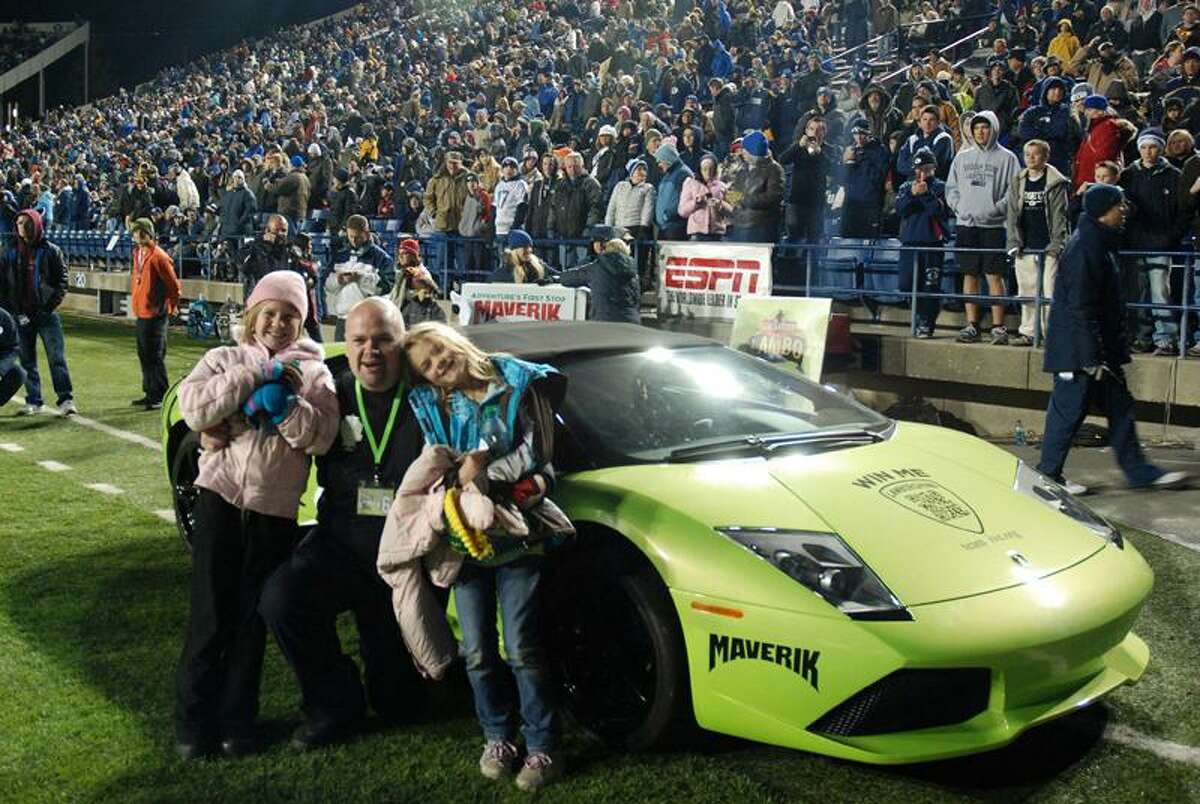 Associated Press David Dopp, 34, of Santaquin, Utah, poses with his daughters Shayla, left, and Olivia, right, after winning a Lamborghini on Nov.12 in Maverik's Sweepstakes at Brigham Young University's LaVell Edwards Stadium in Provo, Utah.