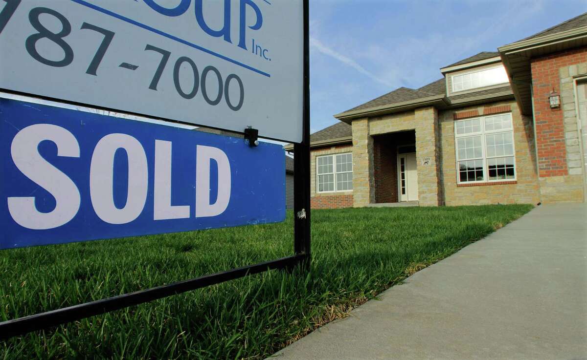 In this photo taken April 18, a sold sign is seen on a recently built new residential home in Illinois. More people bought new homes in March, according to a report out Monday.(AP Photo/Seth Perlman)