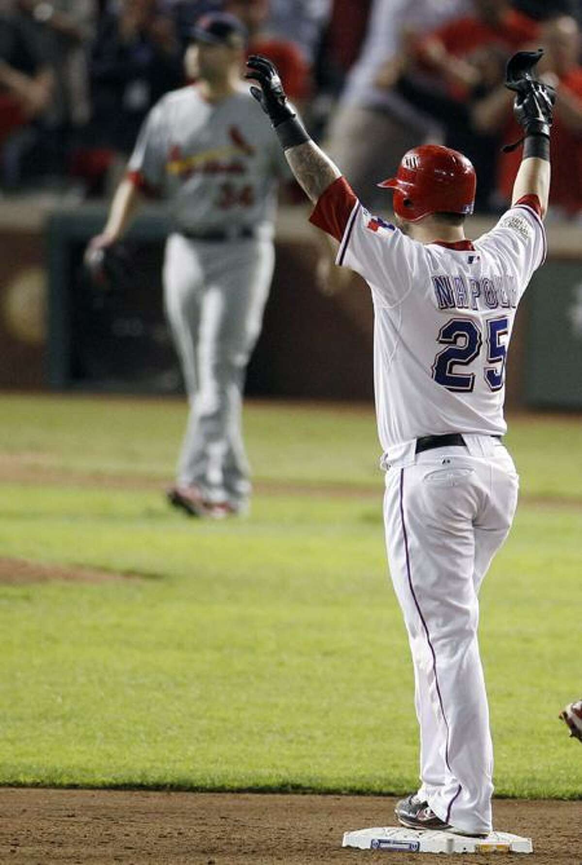 Texas Rangers' Mike Napoli reacts to hitting a two-RBI double off St. Louis Cardinals' Marc Rzepczynski during the eighth inning of Game 5 of baseball's World Series Monday, Oct. 24, 2011, in Arlington, Texas. (AP Photo/Eric Gay)