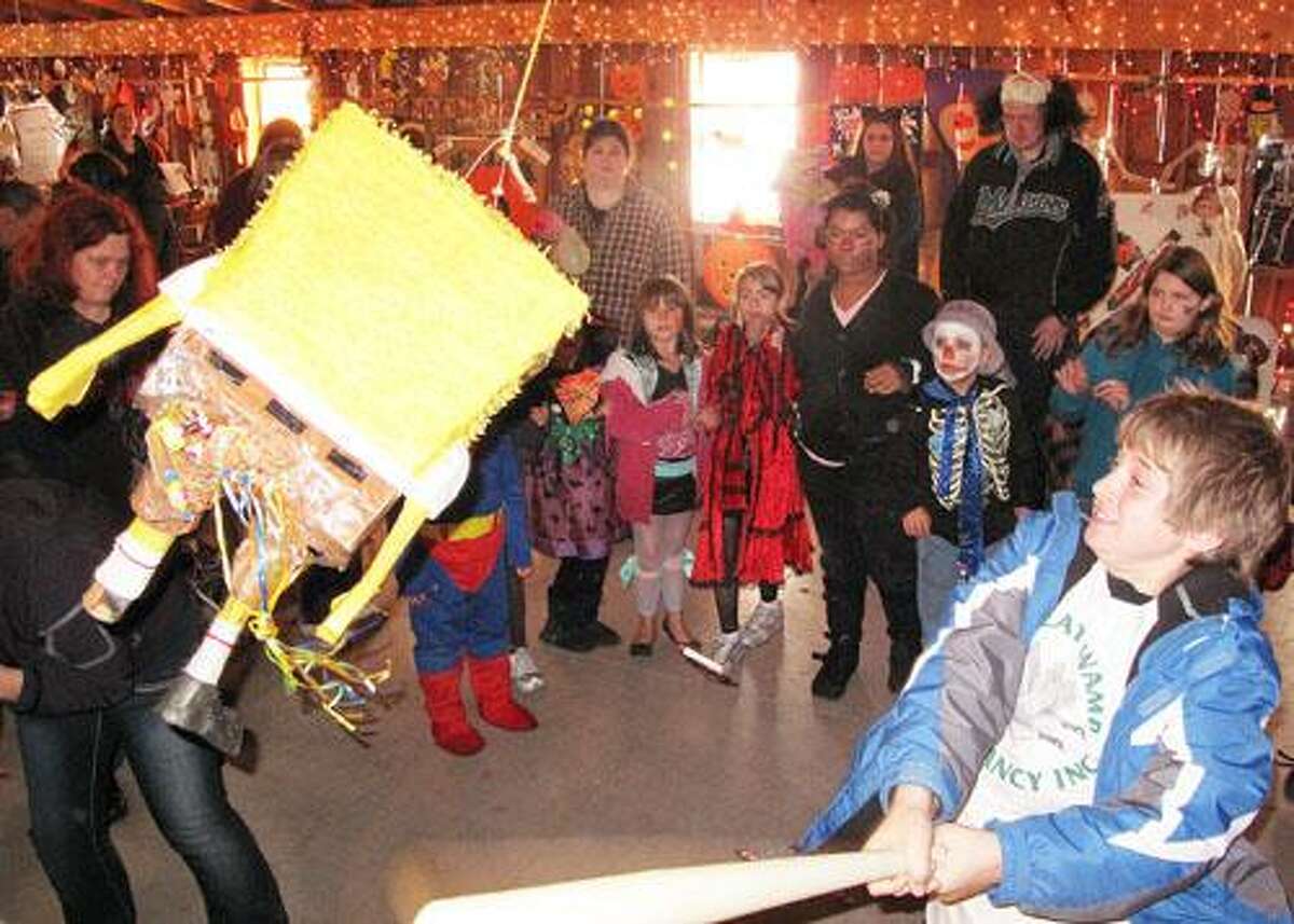 Photo by JOHN HAEGER (Twitter.com/OneidaPhoto) Christian Brazeam, 10, of Chittenango, tries to break a piñata during the Great Swamp's Non-Scary Halloween Party on Sunday, Oct. 23, 2011 at the Great Swamp.