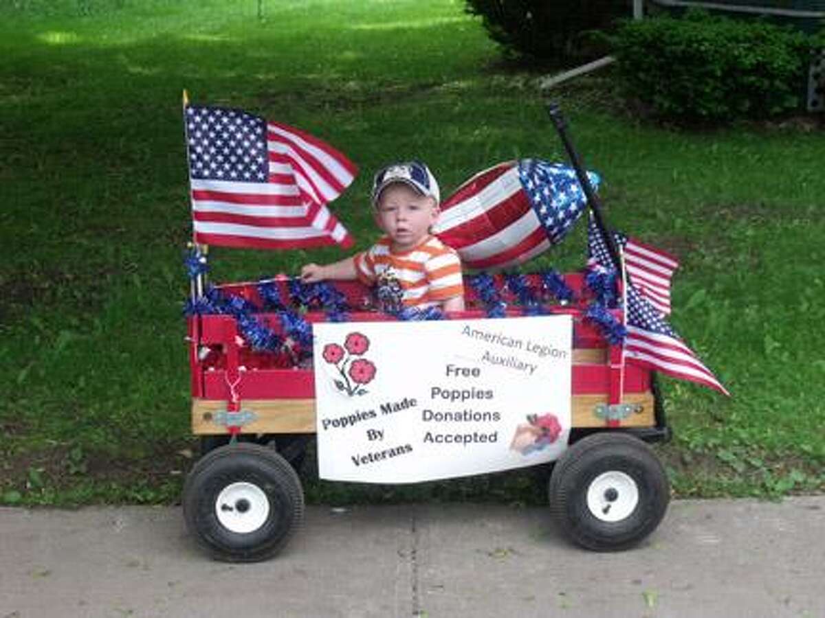 Submitted PhotoAlec France, the youngest Sons of the Munnsville American Legion Post 54 member, volunteered with his Mom to help distribute Poppies during the annual Memorial Day Parade.