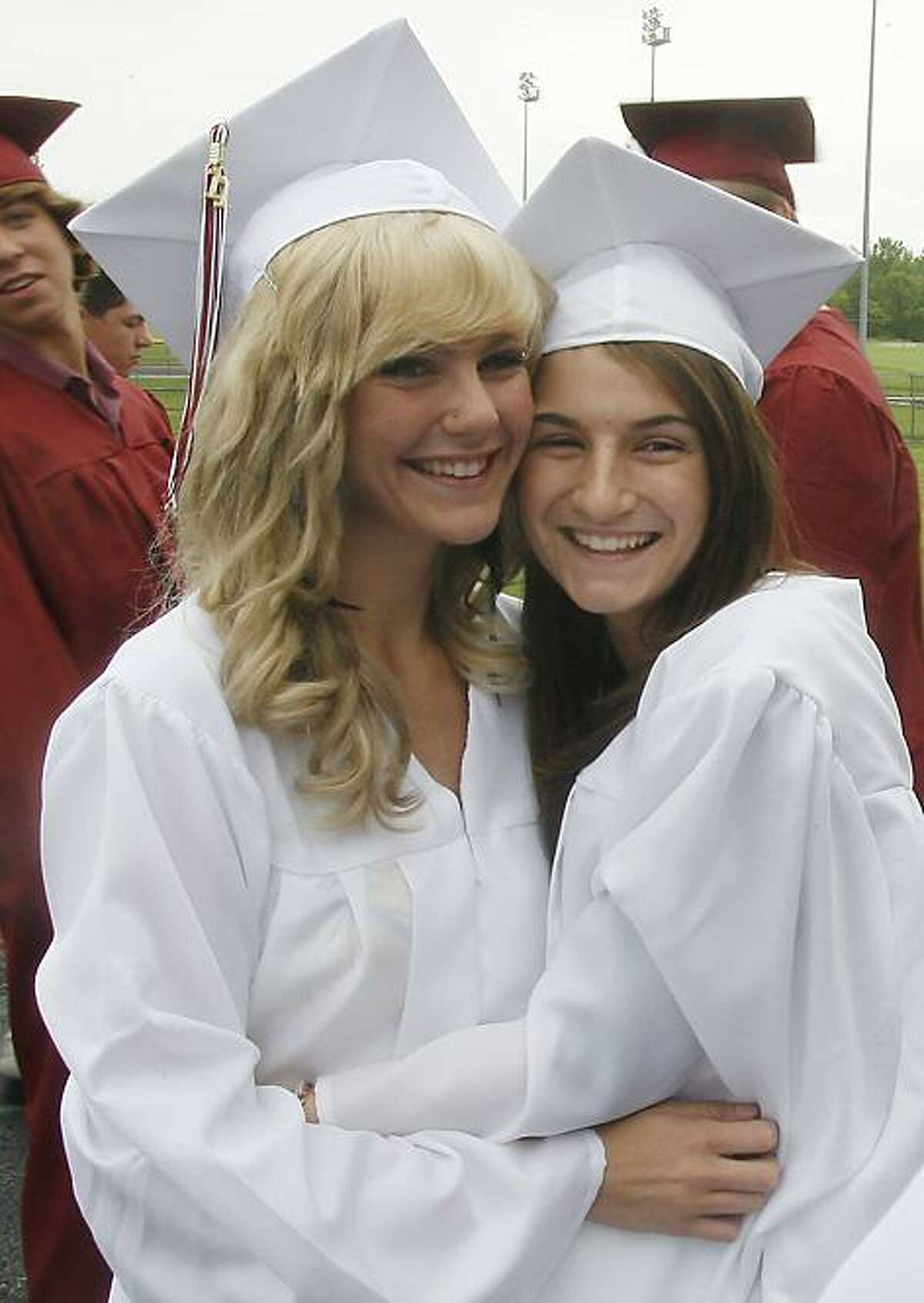 Dispatch Staff Photo by JOHN HAEGERValerie Baer and Ally Bernier pose for a classmate before the start of the 130th commencement exercises at Canastota High School on Saturday, June 25, 2011 in Canastota.