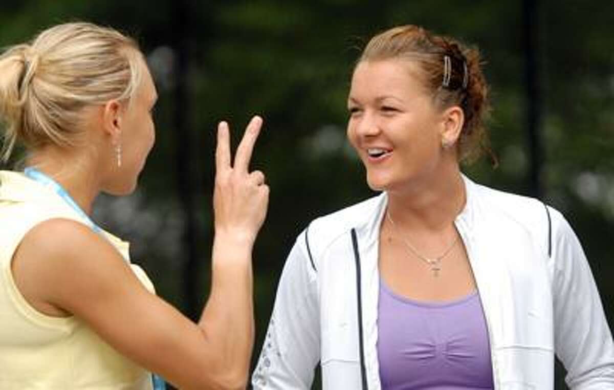 Elena Vesnina, left, and Agnieszka Radwanska, right, both WTA players at the New Haven Open, chat together before the Main Draw announcements Friday 8/19/11 at the Connecticut Tennis Center in New Haven Photo by Peter Hvizdak / New Haven Register August 19, 2011 ph2344 Connecticut