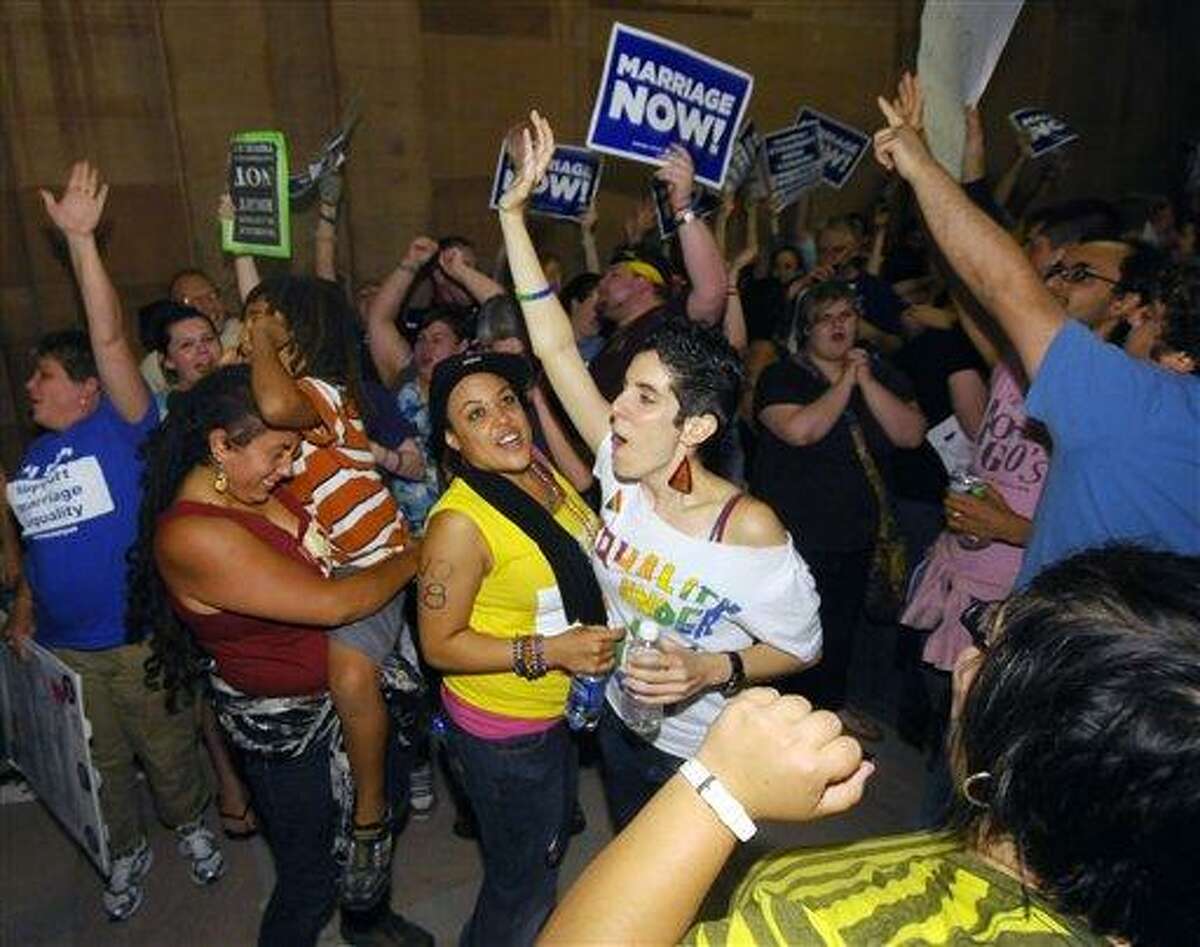 Supporters of same sex marriage celebrate after Senate members voted and approved same-sex marriage at the Capitol in Albany, N.Y., Friday, June 24, 2011. New York lawmakers narrowly voted to legalize same-sex marriage Friday, handing activists a breakthrough victory in the state where the gay rights movement was born. New York will become the sixth state where gay couples can wed and the biggest by far.(AP Photo/Hans Pennink)