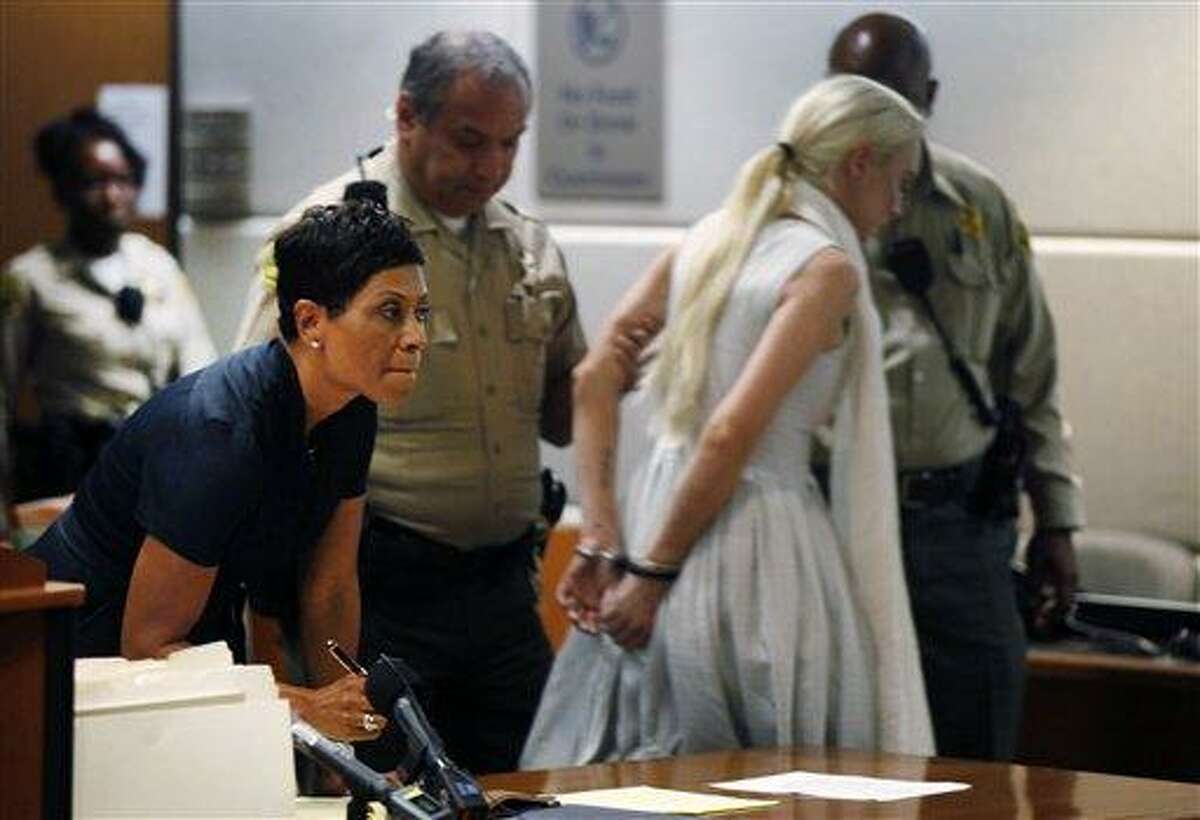 Attorney Shawn Chapman Holley, left, reacts as her client, Lindsay Lohan, is taken into custody by Los Angeles County sheriff's deputies after a judge found her in violation of probation Wednesday in Los Angeles. Lohan did not show up at her community service commitment. (AP Photo)