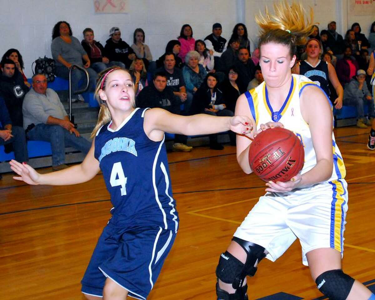 Heidi Schneider, left, of Ansonia defends against Seymour's Christina Cretella in the first half of Ansonia's 49-42 win. Photo by Arnold Gold/New Haven Register