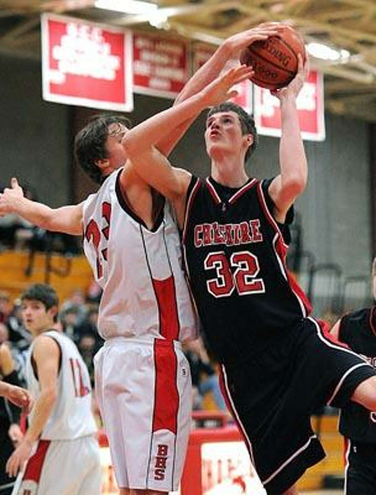 Cheshire's Nate Howard drives to the hoop as Branford's Kyle Nolan defends during the first quarter. Photo by Peter Casolino/New Haven Register 02/24/11 Cas11024