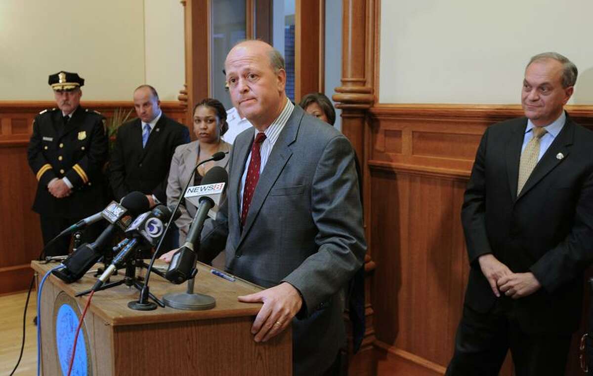 New Police Chief Dean Esserman, center, answers questions after Mayor John DeStefano Jr., right, announced Esserman will replace current Chief Frank Limon during a press conference Tuesday at New Haven City Hall. Peter Casolino/Register