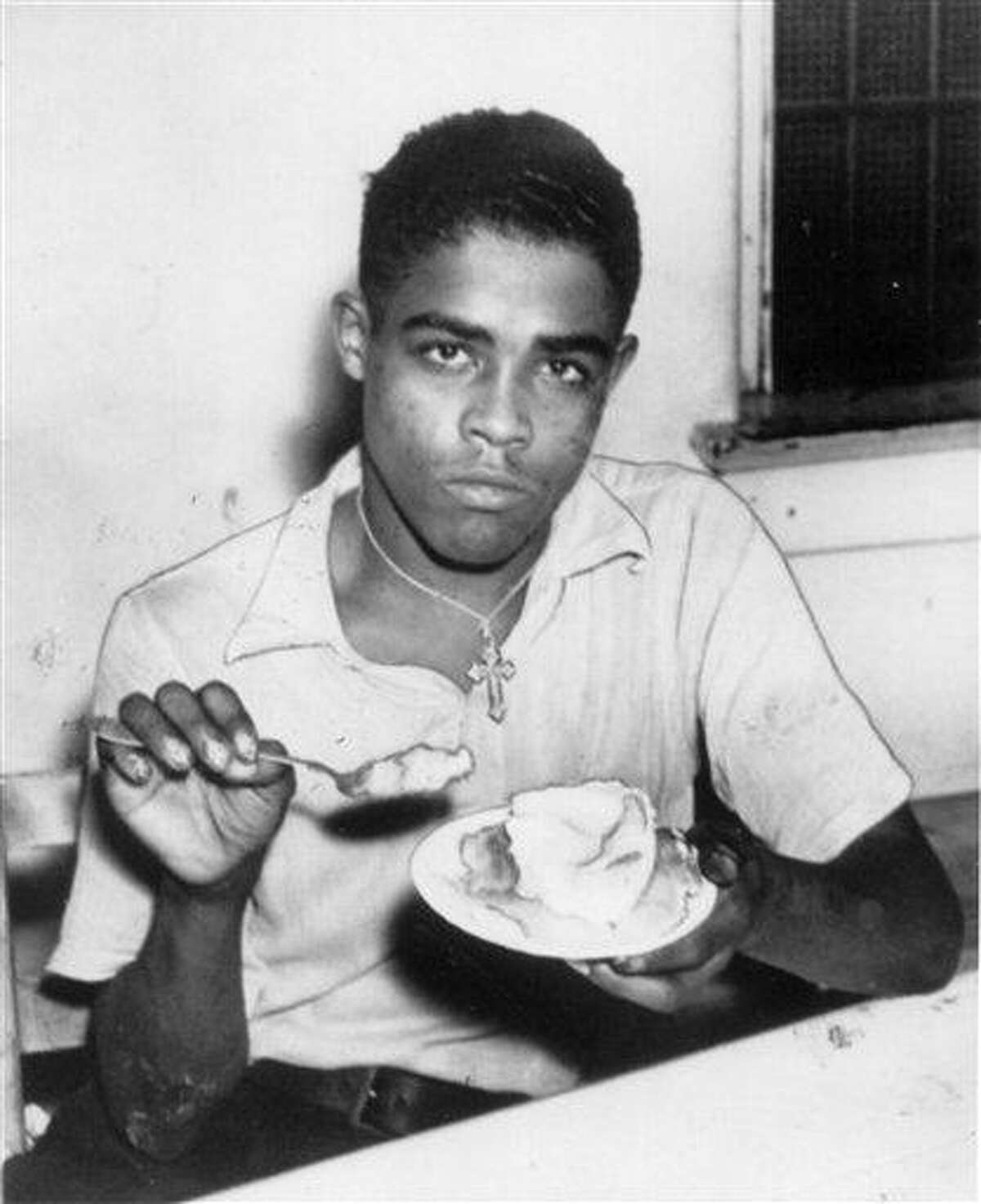 In this Thursday, Aug. 13, 1936 photo, Rainey Bethea has his last meal in Louisville, Ky. before being publicly hanged in Owensboro, Ky. Bethea, a 22-year-old black man convicted of murdering and robbing a 70-year-old white woman, was the last person killed in a public execution in the United States. (AP Photo/The Courier-Journal)