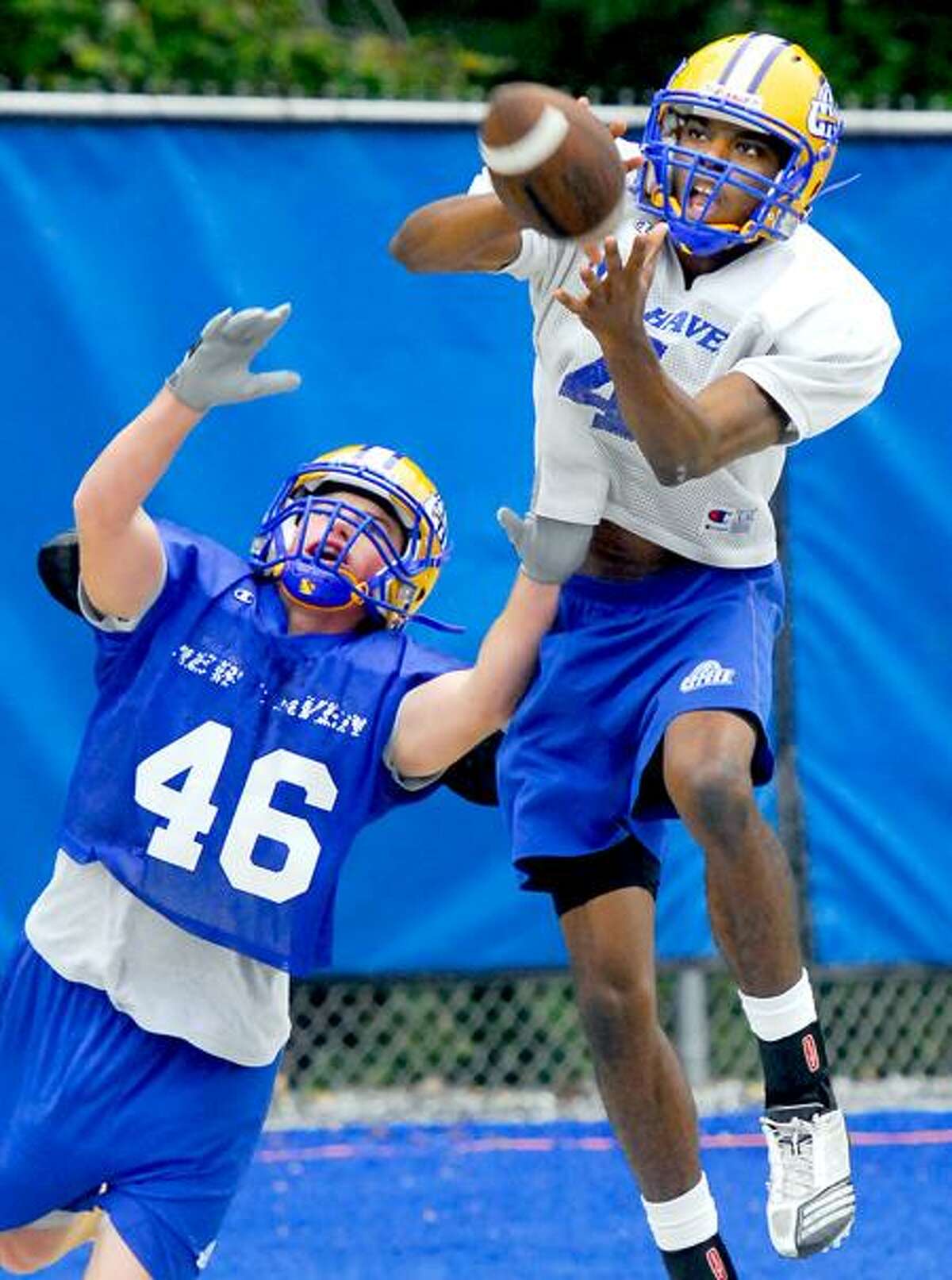 Jason Thompson (right) catches a pass over defender Trevor Officer during practice at UNH in West Haven on 10/12/2011.Photo by Arnold Gold/New Haven Register AG0427A