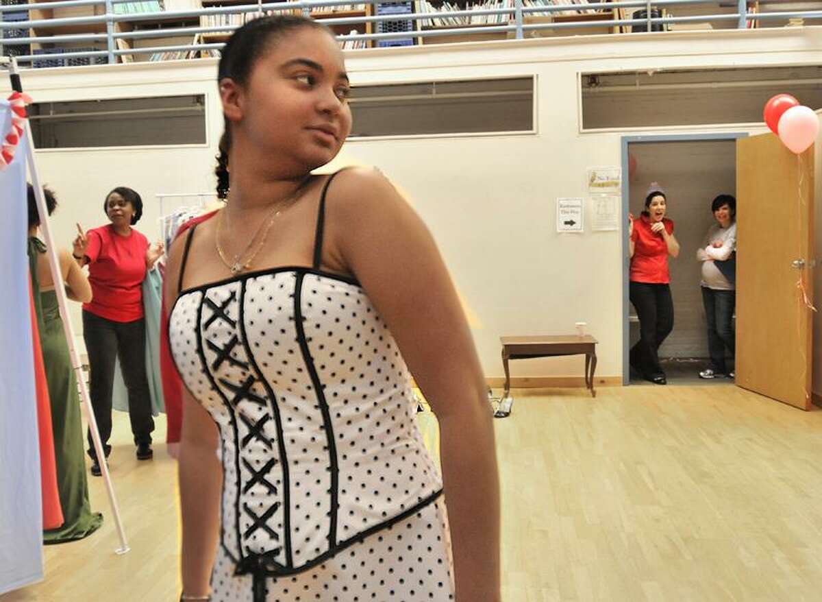 NEW HAVEN-New Haven high school senior, Brittny Blue, checks out a prom dress at LEAP of Greater New Haven. She took the dress. Melanie Stengel/Register