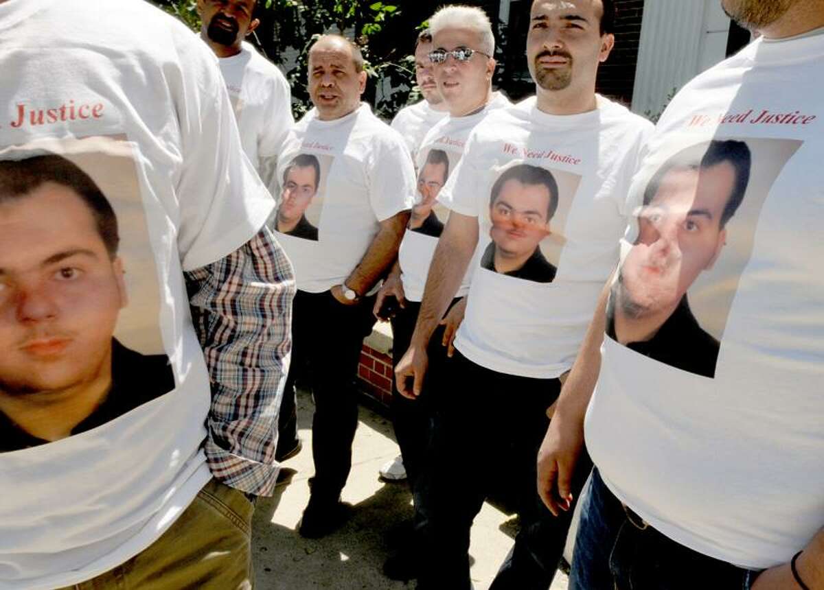 Family and friends of slaying victim Mohamed Bilal "Billy" Altinawi wear T-shirts bearing Altinawi's image outside court in Milford Friday. Peter Hvizdak/Register