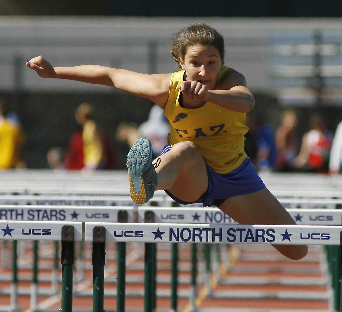 Dispatch Staff Photo by JOHN HAEGERCaz Paige Biviano clears the final hurdle in the 100 meter pent hurdles during the Sec III meet at CNS on Thursday, June 2, 2011.