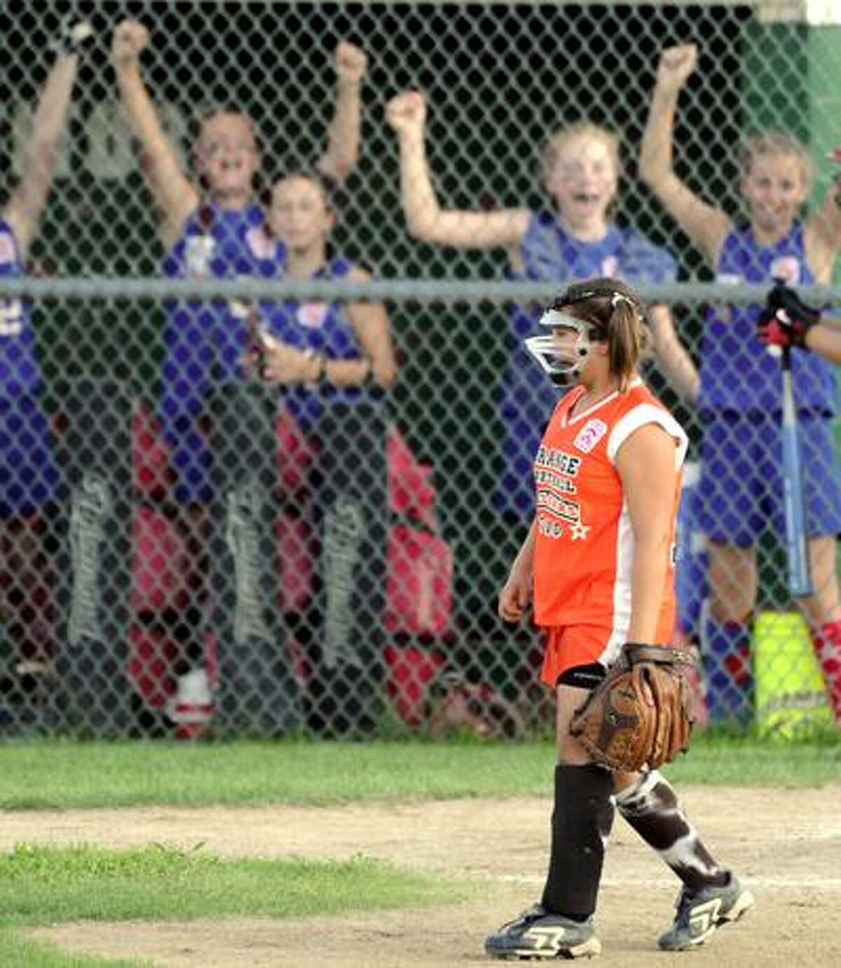 The Waterford bench cheers as a run scores while Orange's Teresa Marchitto looks on during the third inning of Waterford's 7-1 win Tuesday at Whiteley Field in Jewett City. (Peter Hvizdak/Register)
