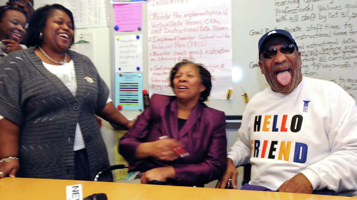 Comedian and educator Bill Cosby visited King/Robinson Interdistrict Magnet IB World School. He was brought to New Haven by SCSU president Stanley Battle. PTO president Alesia Harris left and principal Iline Tracey center crack up after Tracey and Cosby right embraced. Photo by Mara Lavitt/New Haven Register