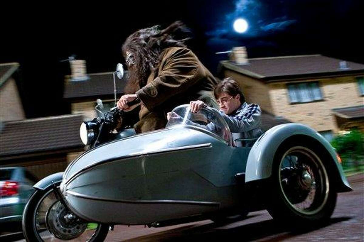 In this film publicity image released by Warner Bros. Pictures, Robbie Coltrane, left, and Daniel Radcliffe are shown in a scene from "Harry Potter and the Deathly Hallows: Part 1." (AP Photo/Warner Bros. Pictures, Jaap Buitendijk)