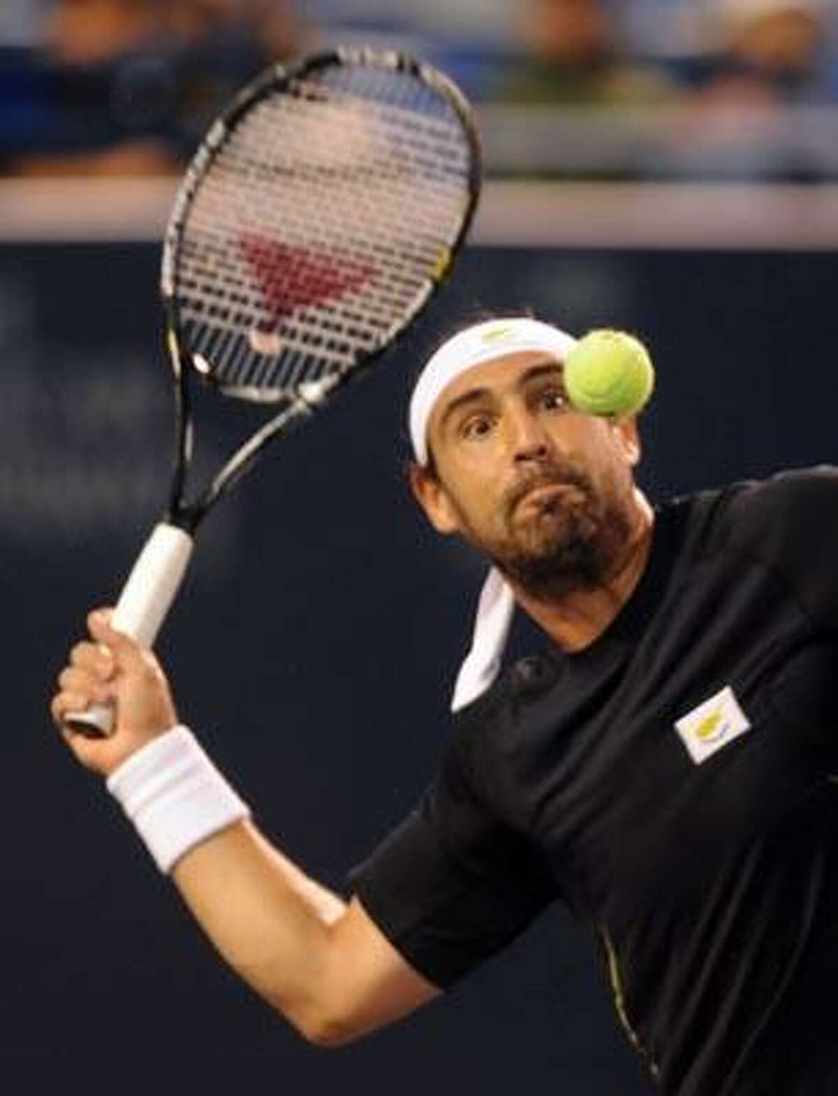 Marcos Baghdatis gives the final point a good look as he smacks it over the net to win against Igor Andreev. (Photo by Mara Lavitt)