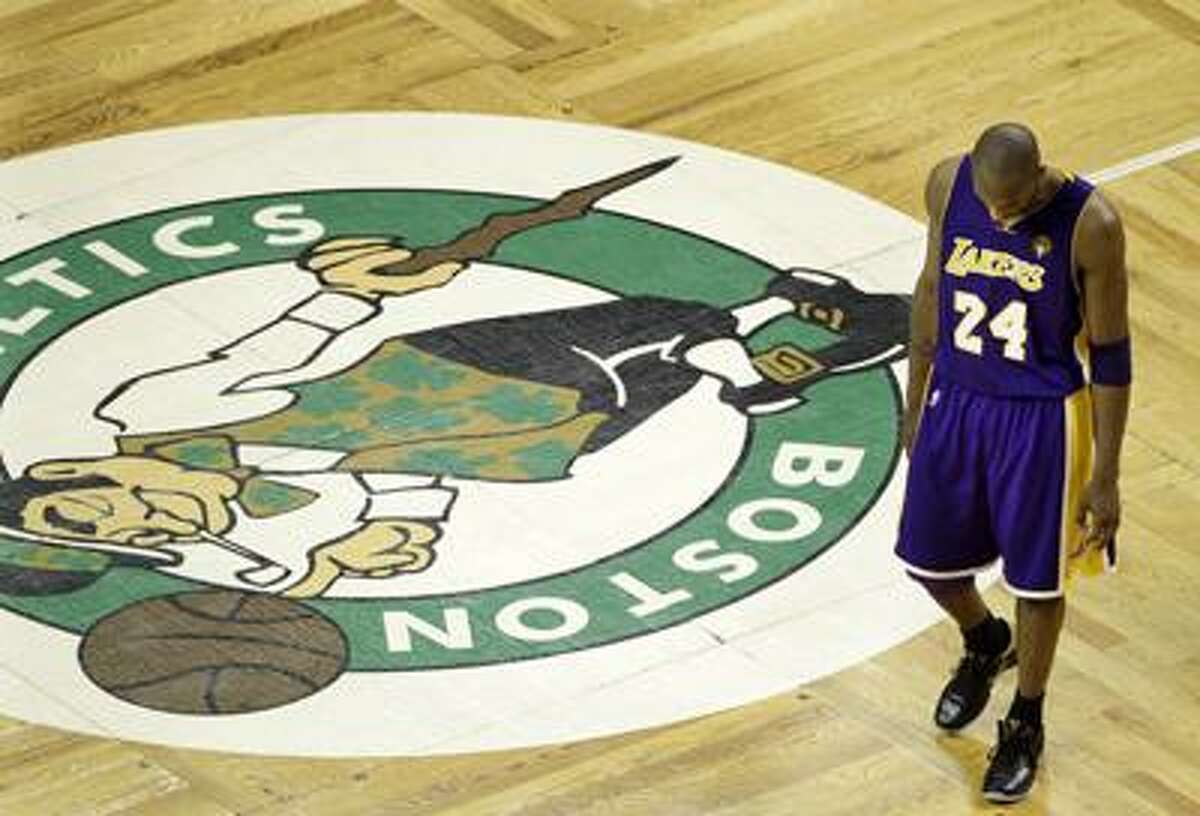 Lakers guard Kobe Bryant walks past the Celtics logo at center court during the fourth quarter of Los Angeles' 92-86 NBA finals Game 5 loss Sunday night in Boston. The two teams play Game 6, with the Celtics leading the series 3-2, tonight in L.A. (Associated Press)