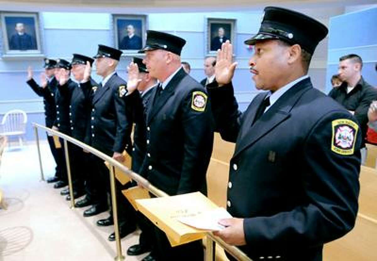 Left to right - Robert Balkun, Mathew Carter, Thomas Connors, Thomas Corrone, Ryan Doherty, Frank Filardo and Theodore Oliver are sworn in during the New Haven Regional Fire Training Academy's 55th Academy Class Graduation at New Haven City Hall on 8/11/2010.Photo by Arnold Gold AG0380F