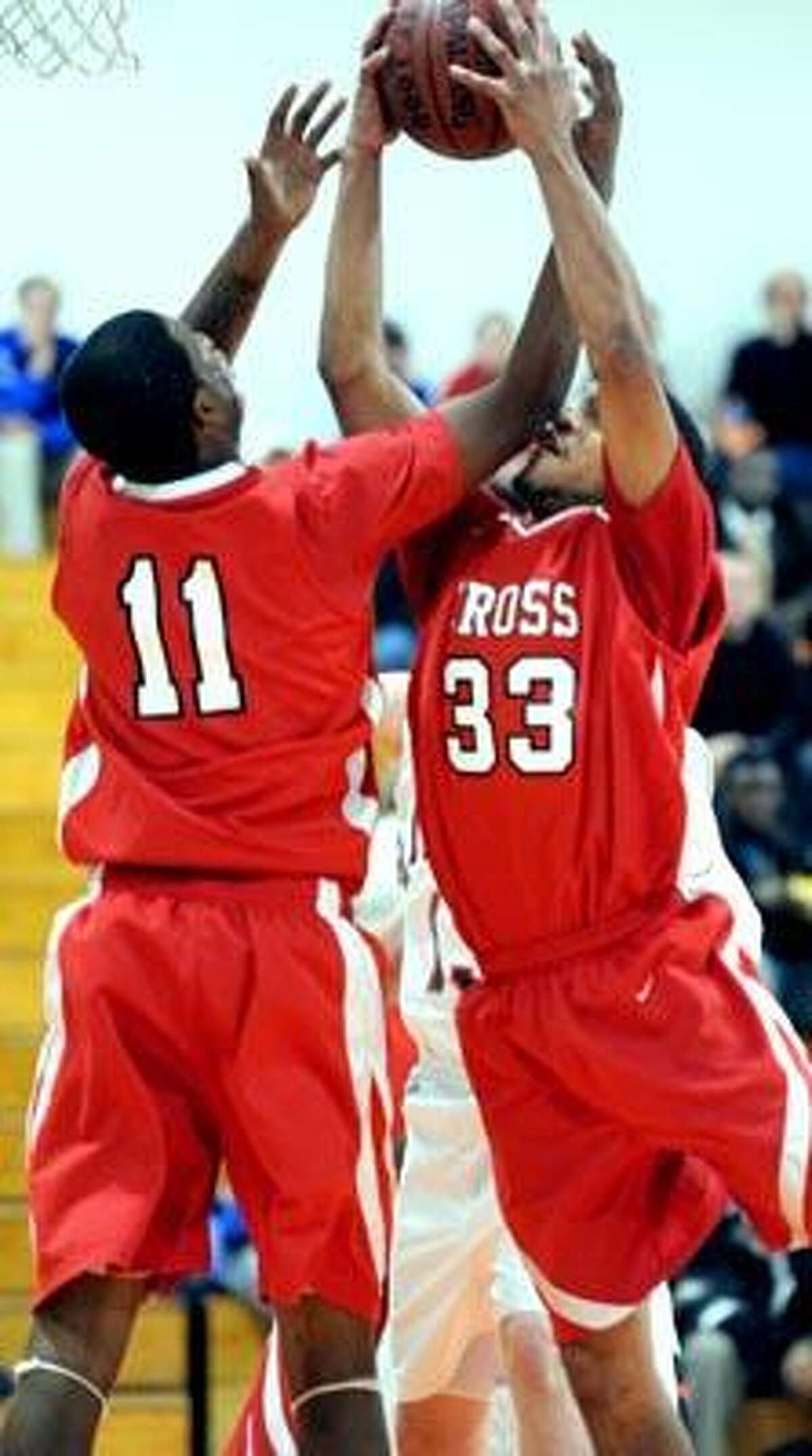 Dontay Long (left) and Kyle Holmes (right) of Wilbur Cross grab a rebound against Lyman Hall in the first half on 12/15/2010.Photo by Arnold Gold/New Haven Register AG0396A