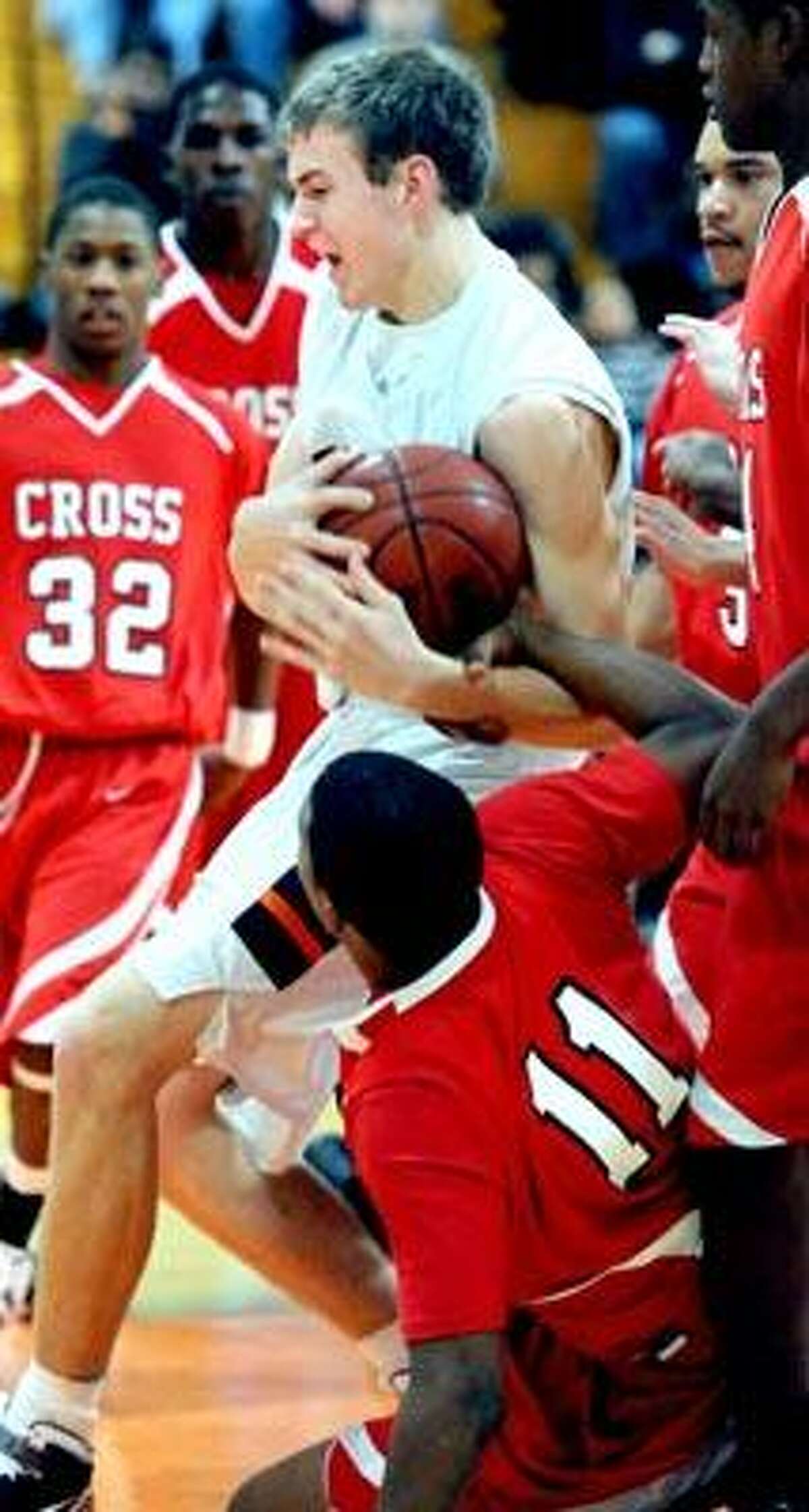 Dontay Long (bottom) of Wilbur Cross grabs the arm of Lyman Hall's Jason Dempsey in the first half on 12/15/2010.Photo by Arnold Gold/New Haven Register AG0396A