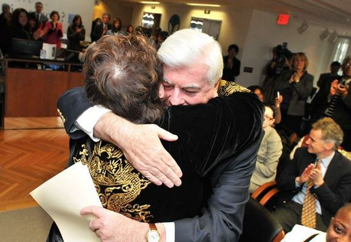 New Haven-- Senator Chris Dodd gets a hug from Patricia Russo, former Chairwoman of the Permanent Commission on the Status of Women, during a ceremony thanking Dodd for his efforts on behalf of women. Dodd was instrumental in the passing of the Family Medical Leave Act. The event was held at the Community Foundation of Greater New Haven. Photo by Peter Casolino/New Haven Register 12/13/10 Cas101213