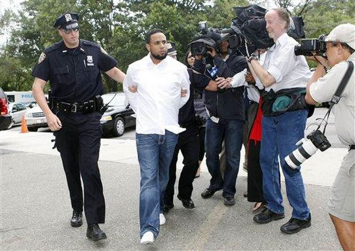 New York Mets baseball pitcher Francisco Rodriguez is led into Queens Criminal Court Thursday, Aug. 12, 2010, in New York. Rodriguez was suspended for two days by the team Thursday, a day after he was charged with assaulting his father-in-law at a Citi Field family lounge following a game. (AP Photo/Jason DeCrow)