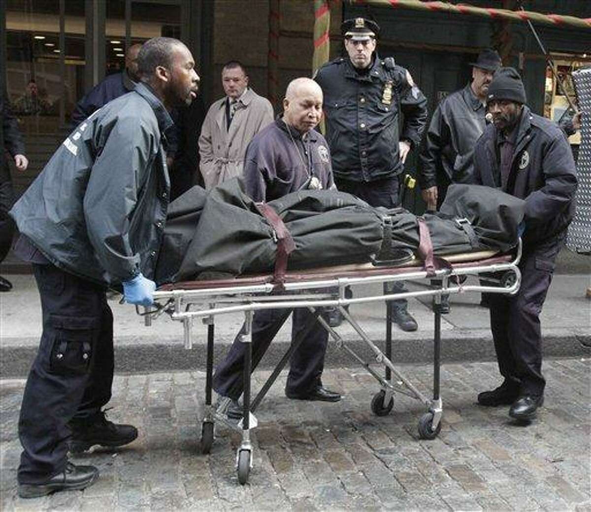 Medical examiner staff remove the body of Mark Madoff from the apartment building in which he lived, Saturday, Dec. 11, 2010 in the Soho neighborhood of New York. Mark Madoff, the eldest son of disgraced financier Bernard Madoff, hanged himself by a dog leash in his apartment Saturday after two years of "unrelenting pressure" following his father's arrest in a multibillion-dollar fraud that enveloped the entire family, law enforcement officials and a family attorney said. (AP Photo/Mary Altaffer)