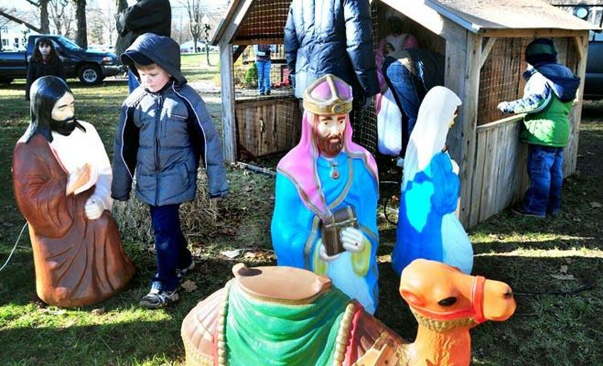 Christopher Carroll (left), 6, of Booth Hill School Cub Scout Pack 24 walks through Nativity figures being set up by the Cub Scouts and the Shelton Exchange Club on the Huntington Green in Shelton on 12/4/2010.Photo by Arnold Gold/New Haven Register AG0395B