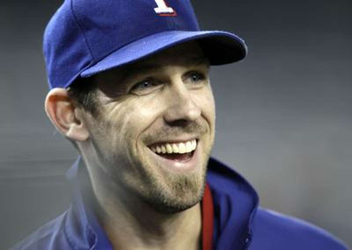 FILE - This Oct. 18, 2010, file photo shows Texas Rangers starting pitcher Cliff Lee smiling after the Rangers' 8-0 win over the New York Yankees in Game 3 of baseball's American League Championship Series, in New York. On Wednesday, Dec. 8, 2010, the New York Yankees made an offer to Lee, a six-year proposal worth nearly $140 million. (AP Photo/Charles Krupa, File)