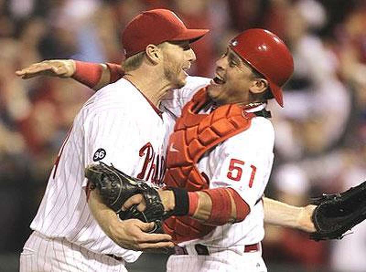Philadelphia Phillies starting pitcher Roy Halladay, left, celebrates with catcher Carlos Ruiz (51) after throwing a no-hitter to defeat the Cincinnati Reds 4-0 during Game 1 of baseball's National League Division Series, Wednesday, Oct. 6, 2010, in Philadelphia. (AP Photo/Rob Carr)