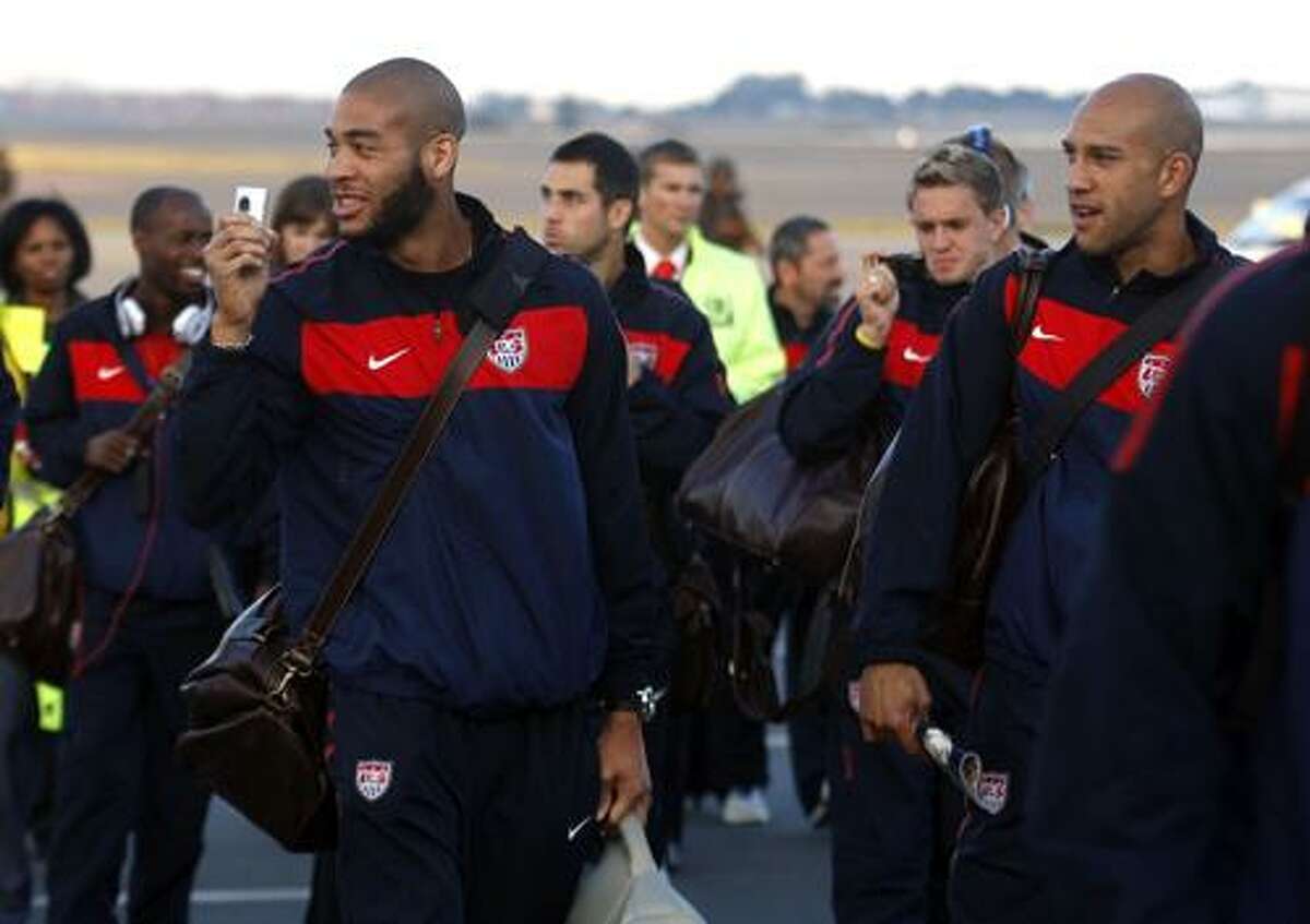 United States soccer player Oguchi Onyewu, left, and teammates arrive Monday at the O.R. Tambo International Airport in Johannesburg. The World Cup begins on June 11, the U.S. plays June 12. (Associated Press)