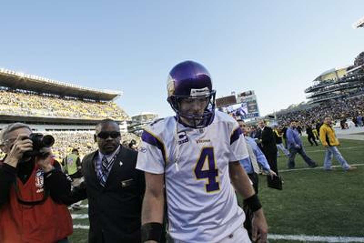This Oct. 25, 2009 file photo shows Minnesota Vikings quarterback Brett Favre walking off Heinz Field after a 27-17 loss to the Pittsburgh Steelers. A person with knowledge of the situation tells The Associated Press that Brett Favre has informed the Vikings he will not return to Minnesota for a second season. The person spoke on condition of anonymity Tuesday because the team had not made an official announcement. (Associated Press/Gene J. Puskar)