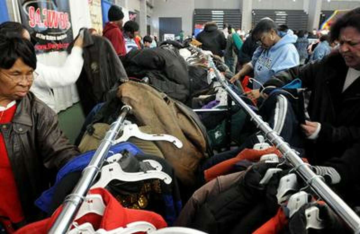 New Haven--New Haven community members sift through donated jackets at Sunday's winter coat distribution at the New Haven fieldhouse. The New Haven Firebird society was among the sponsors. Photo by Brad Horrigan/New Haven Register-12/05/10.