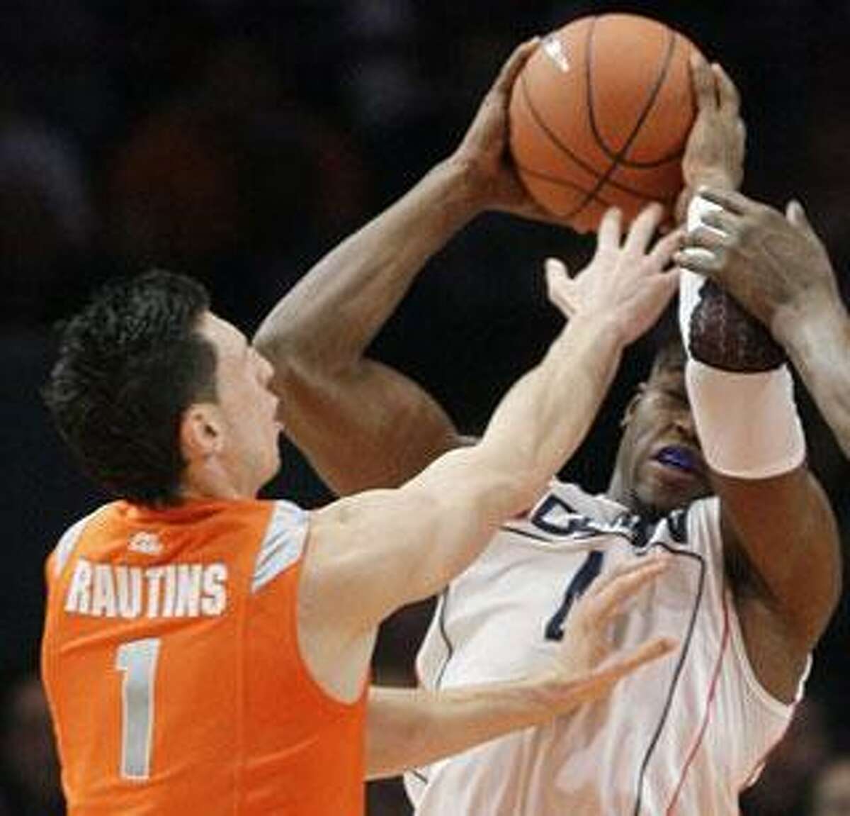 Syracuse's Andy Rautins, left, defends Connecticut's Jeff Adrien in the first half of an NCAA college basketball game in the quarterfinals of the Big East men's tournament Thursday, March 12, 2009, at Madison Square Garden in New York. (AP Photo/Julie Jacobson)