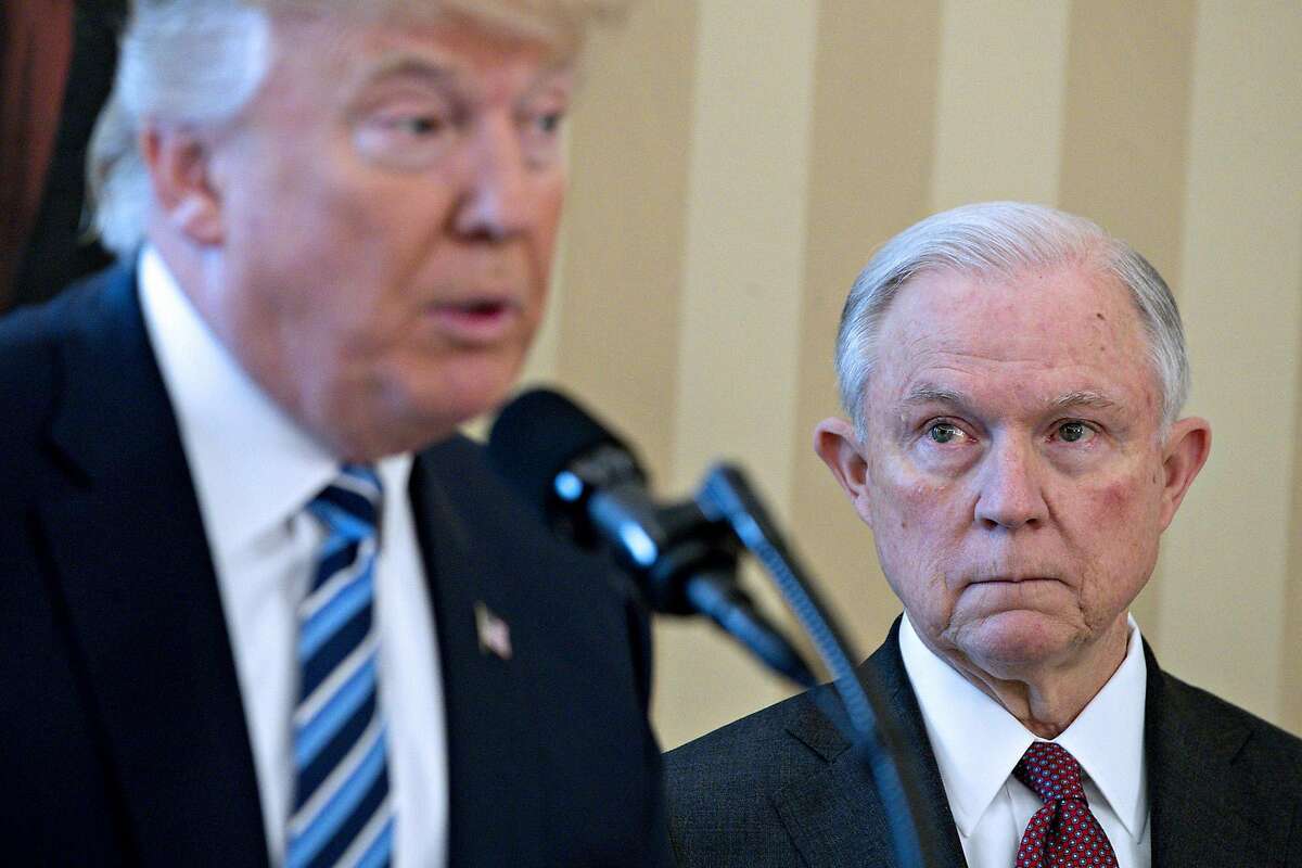 Attorney General Jeff Sessions (right) listens as President Donald Trump speaks at Sessions' swearing in ceremony in the White House on Feb. 9, 2017. MUST CREDIT: Bloomberg photo by Andrew Harrer.
