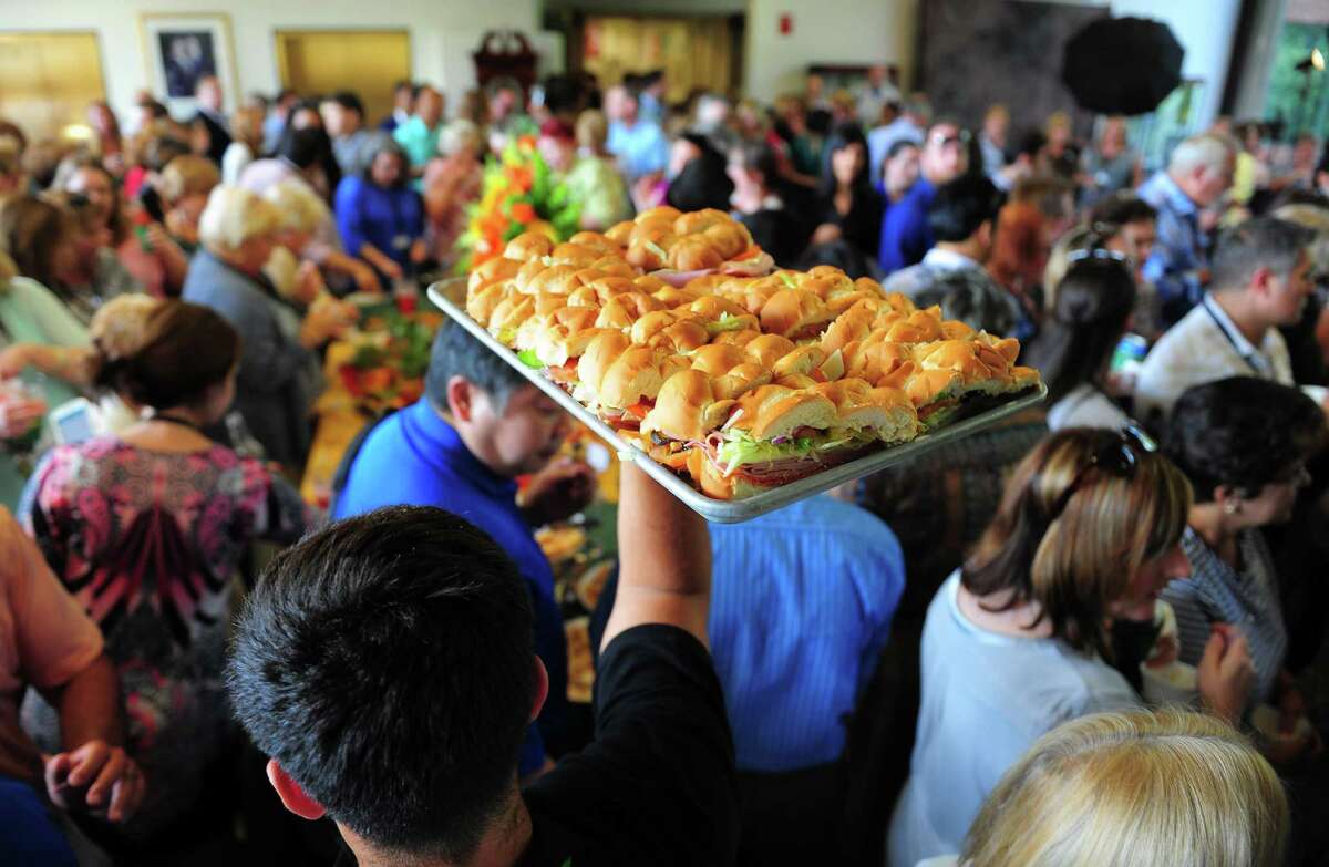 A caterer holds up a tray of Subway sandwiches during the company’s 50th anniversary celebration in 2015.