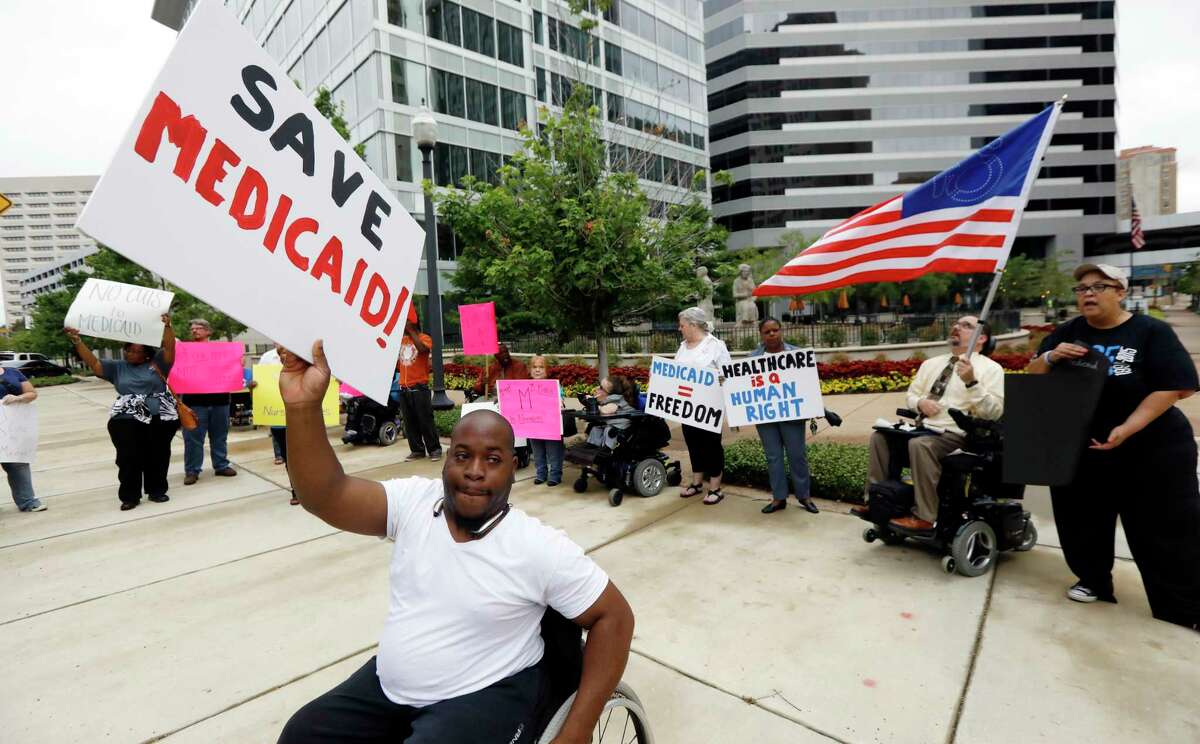 Mario Henderson leads chants of "save Medicaid," as other social service activists, Medicaid recipients and their supporters stage a protest outside the building that houses the offices of U.S. Sen. Thad Cochran, R-Miss., Thursday, June 29, 2017, in Jackson, Miss. Soaring prices and fewer choices may greet customers when they return to the Affordable Care ActÂ?’s insurance marketplaces in the fall of 2017, in part because insurers are facing deep uncertainty about whether the Trump administration will continue to make key subsidy payments and enforce other parts of the existing law that help control prices. (AP Photo/Rogelio V. Solis)
