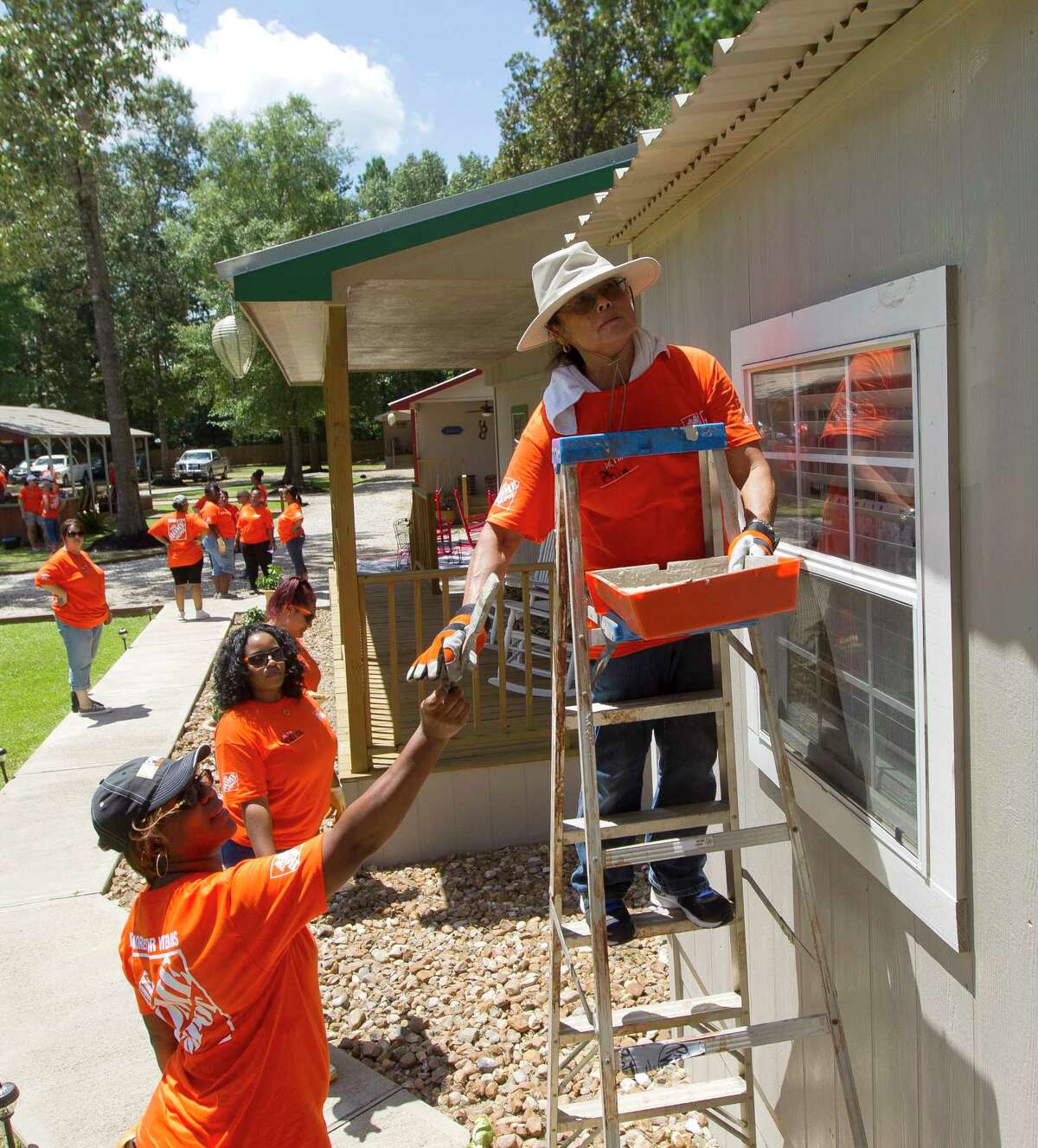 Phil Schiffman works on painting a cottage at Hope Cancer Retreat, Thursday, July 27, 2017, in Splendora. Ten Home Depot stores gathered at the non-profit to work on various projects from landscaping to painting. The organization offers housing to those seeking cancer treatment in Houston for $25 a night for up to three months.