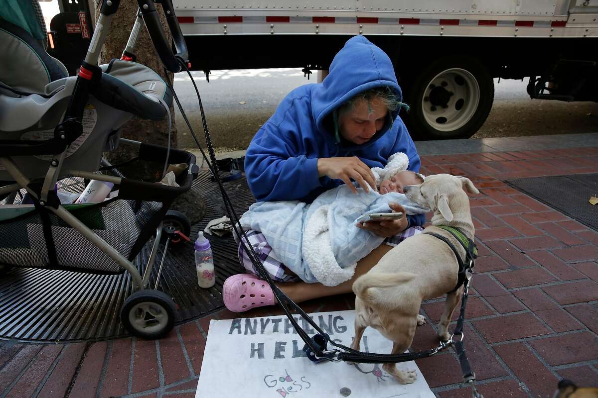 Megan Doudney tends to her two month old daughter Nedhailla as she sits on Market Street on Wednesday, July 26, 2017 in San Francisco, Calif.