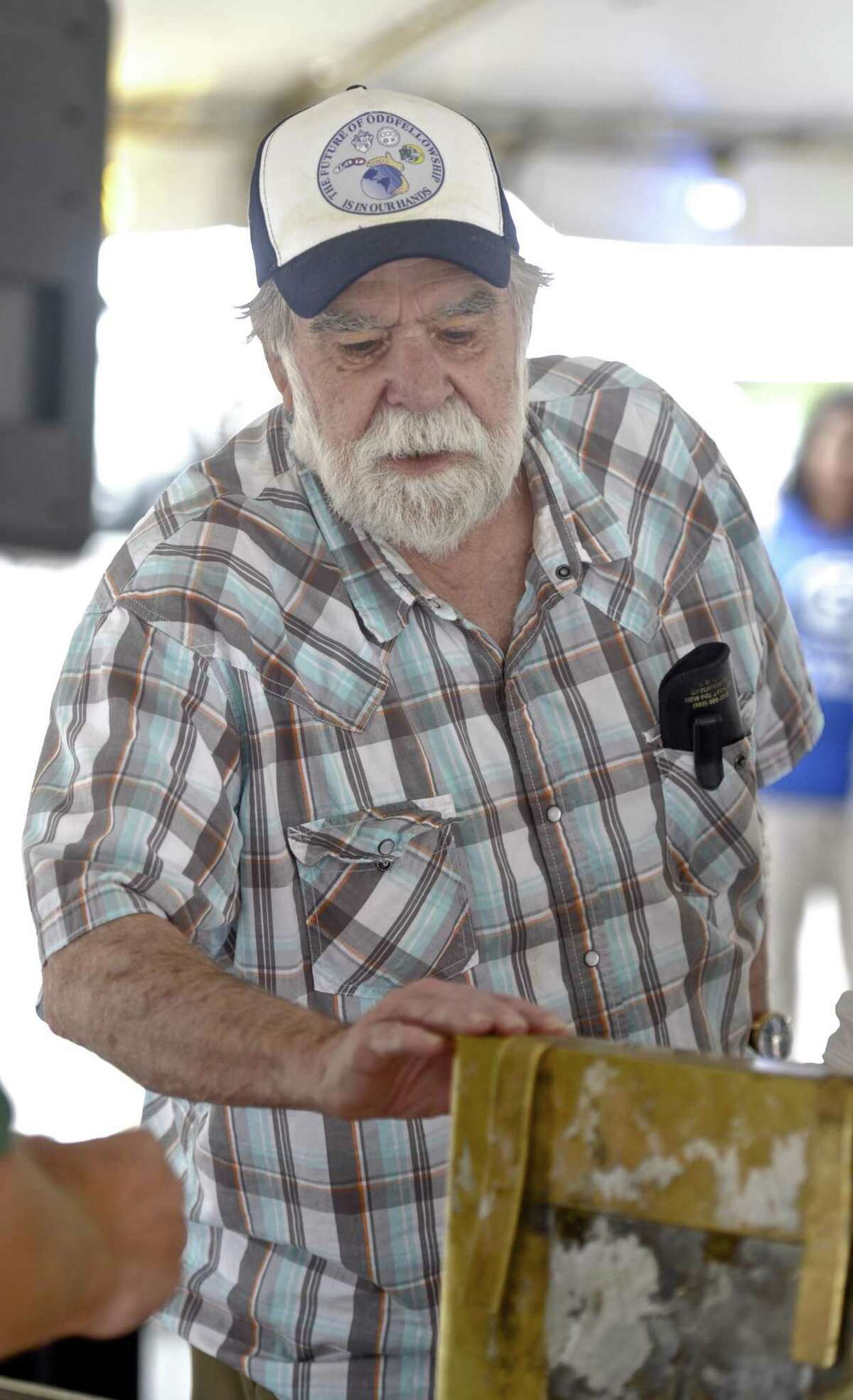 Warren Smith, of New Milford, touches a time capsule from the Scovill (Century Brass) building which was opened during the Village Fair Days in New Milford, on Saturday. Smith was working for Turner Construction, which built the building, and was present when the time capsule was placed in the building, he later worked for Scovill. July 29, 2017, in New Milford, Conn.