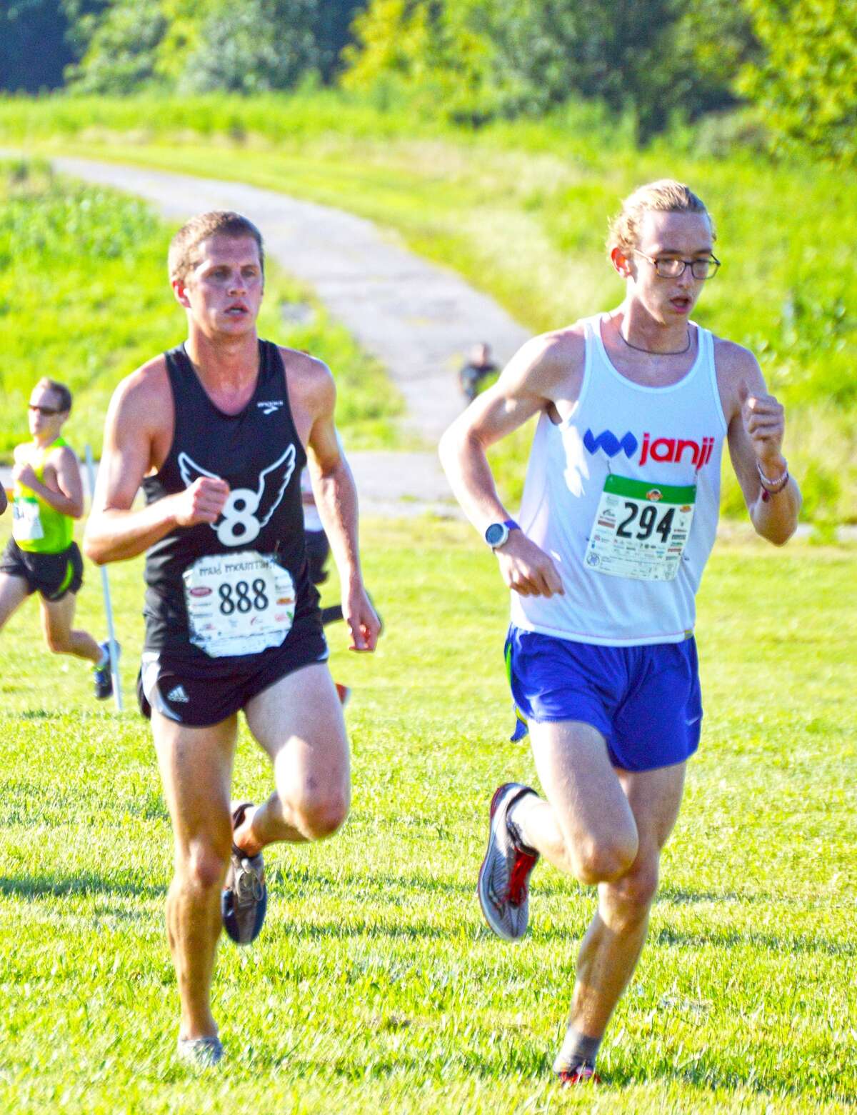Edwardsville’s Eric Johannigmeier, left, and Granite City’s Andrew O’Keefe, right, compete in the 22nd Mud Mountain on Saturday at SIUE.