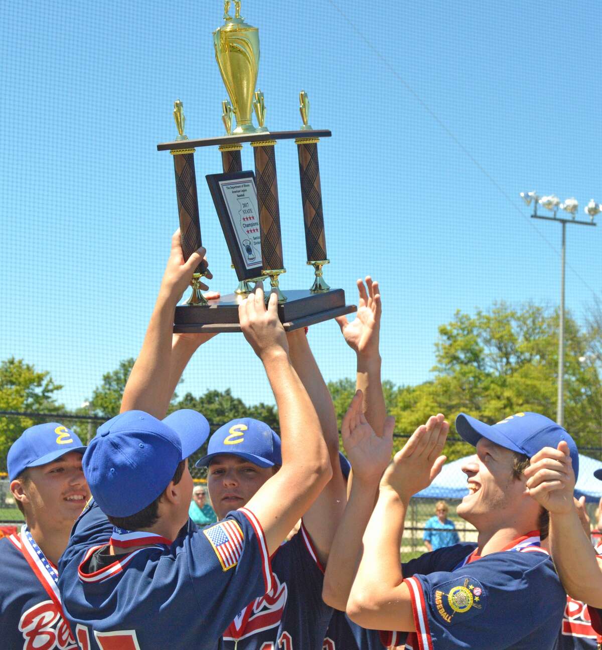 Edwardsville Bears players hoist the first-place trophy after beating Danville on Saturday in the championship game of the senior American Legion tournament at Wabash Park in Rantoul.