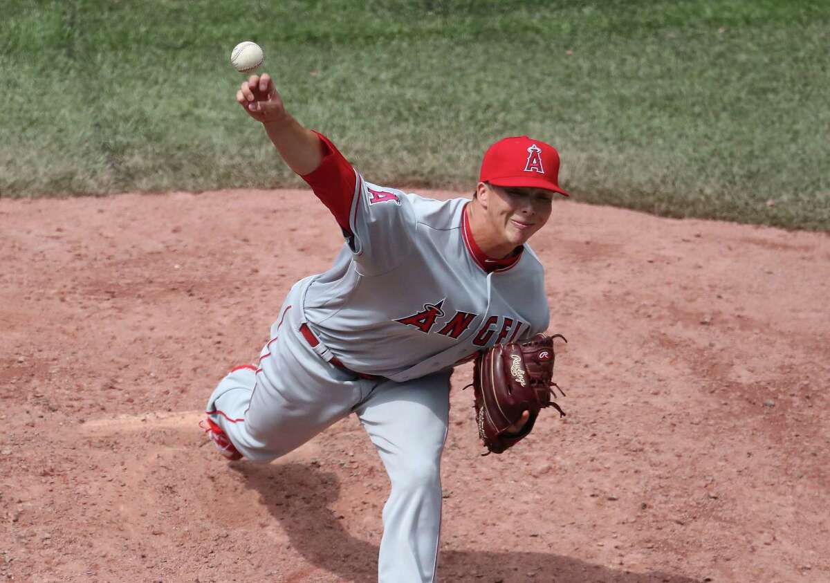 The Angels’ Tro y Scribner delivers a pitch in the sixth inning against the Blue Jays Saturday in Toronto . The S hepaug High grad eanred a win in his major le ague debut.