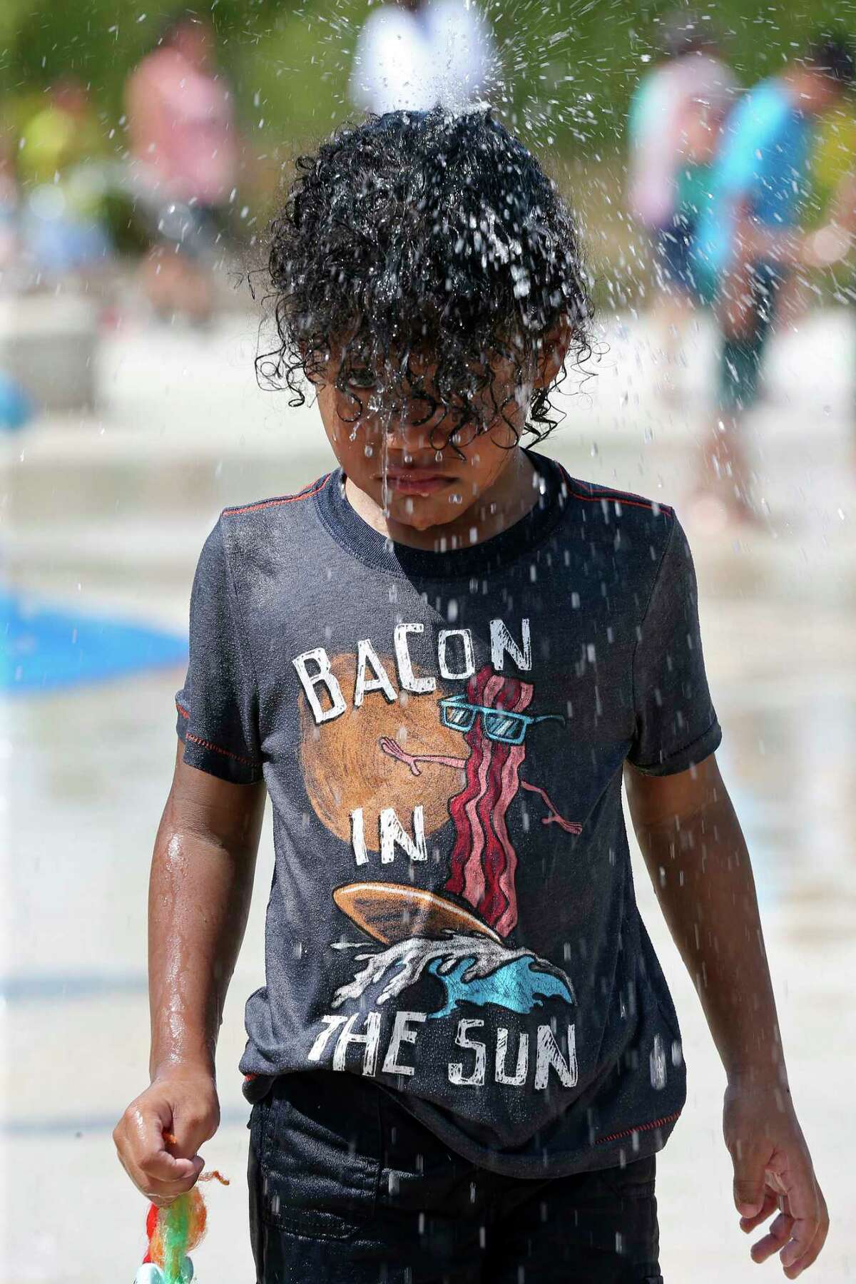 Ruben Longoria-Cordova, 4, plays at the Pearsall Park Splashpad, Sunday, July 30, 2017. According to the National Weather Service, temperature reached 104 degrees Fahrenheit Sunday afternoon.