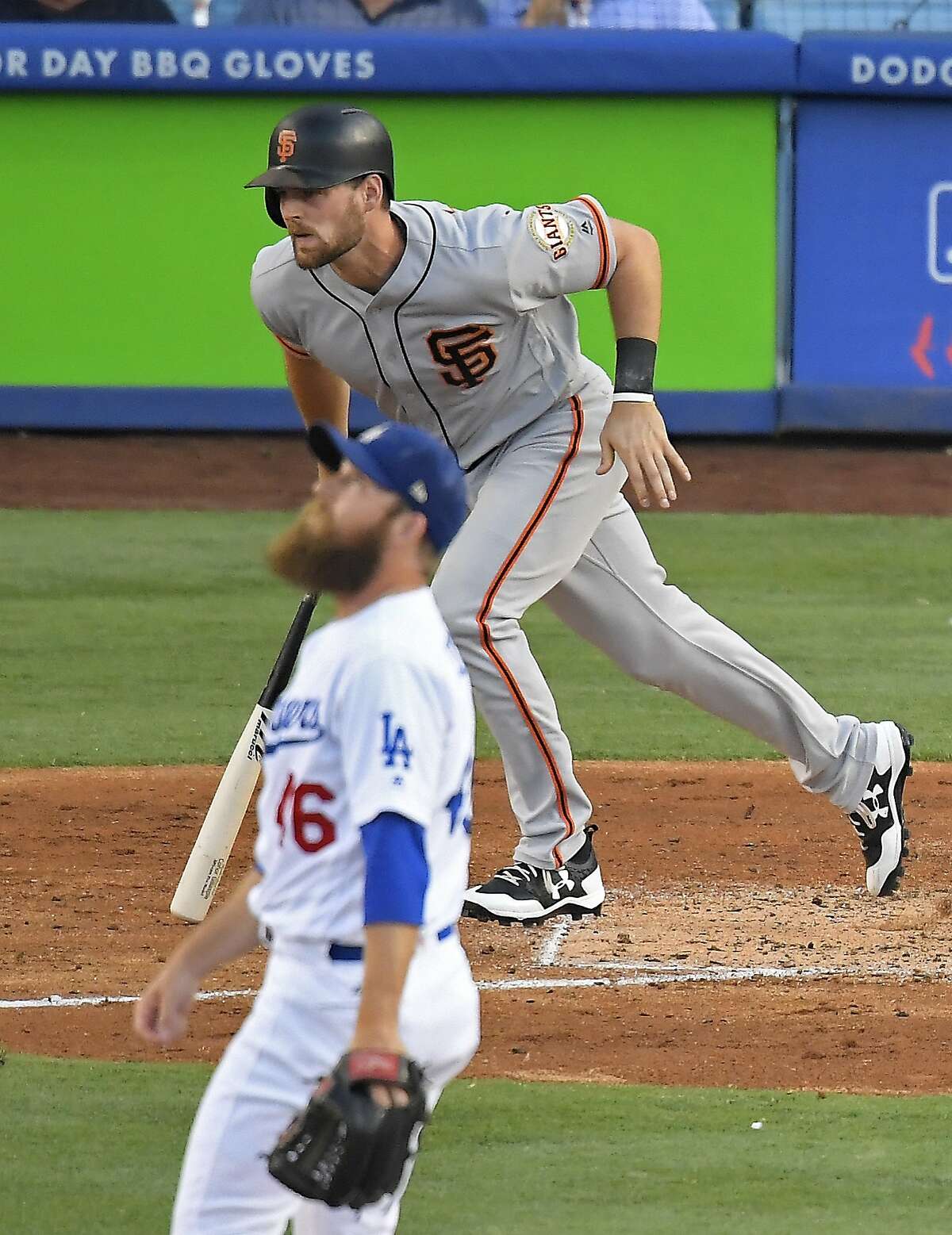 San Francisco Giants' Conor Gillaspie, top, runs the bases after hitting a solo home run as Los Angeles Dodgers relief pitcher Josh Fields watches during the eighth inning of a baseball game Sunday, July 30, 2017, in Los Angeles. (AP Photo/Mark J. Terrill)