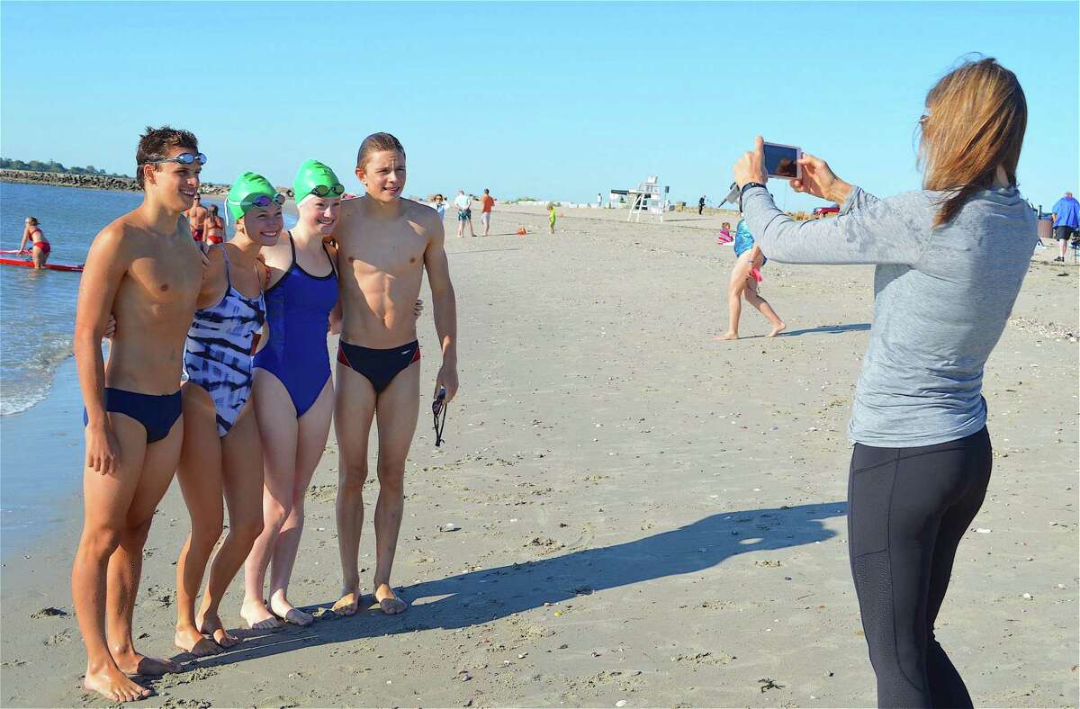 Liz West of Westport photographs Water Rats, from left, Austin Twiss, 16, of Westport, Delaney Walsh, 18, and Caroline Sergeant, 16, of Trumbull, and Jacob West, 16, of Westport, at the 39th annual Westport Weston Family YMCA's Point-to-Point Compo Beach Swim, Sunday, July 30, 2017, in Westport, Conn.