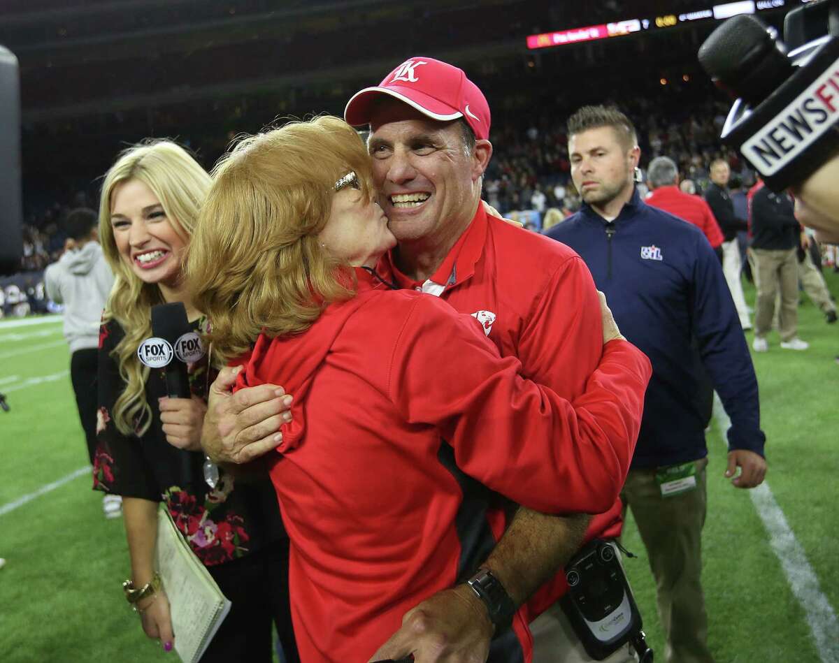 Katy's head coach Gary Joseph gets a kiss from his wife after the team's 34-7 win over Austin Lake Travis at NRG Stadium on Saturday, Dec. 19, 2015, in Houston. Katy won the title 34-7. ( Elizabeth Conley / Houston Chronicle )